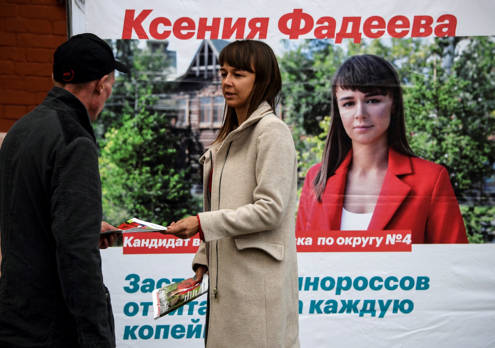 Ksenia Fadeyeva, 28, the head of Alexei Navalny's Tomsk headquarters and the city council candidate in September 13 regional elections, distributes campaign leaflets in the Siberian city of Tomsk on September 7, 2020.