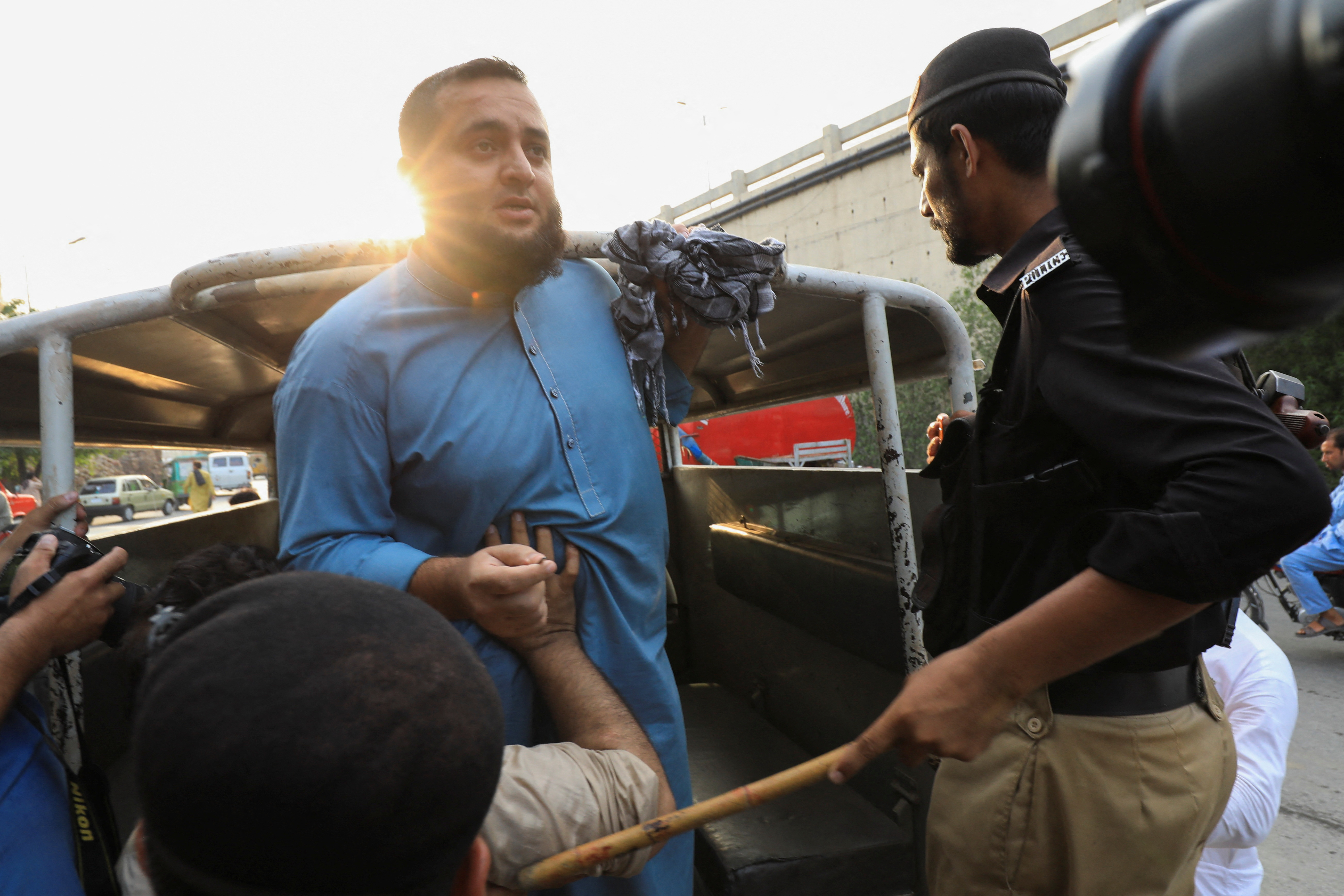Police officer detains a supporter