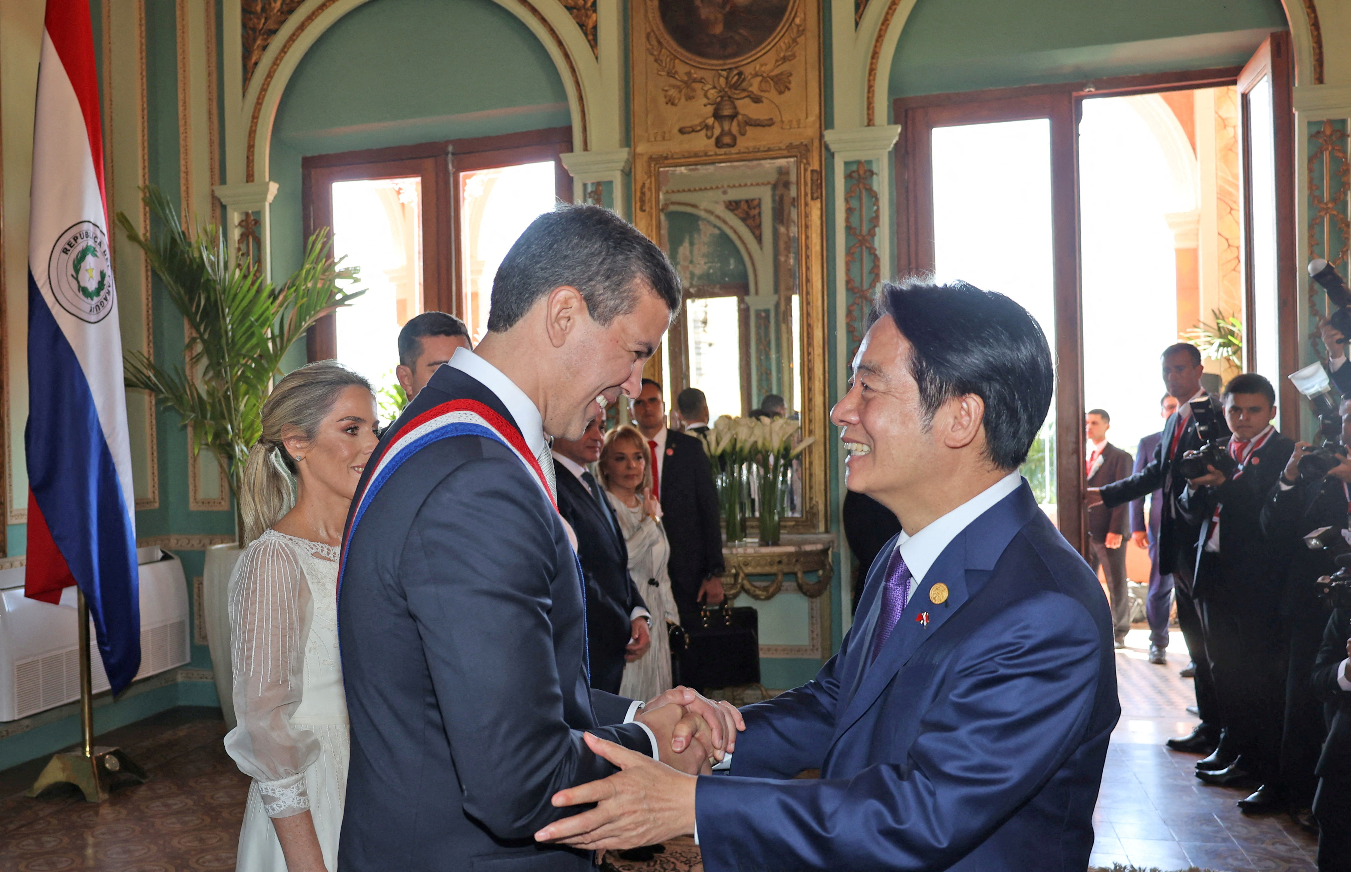 Paraguay's new President Santiago Pena shakes hands with Taiwan's Vice President William Lai shaking hands at Pena's inauguration. The two men look friendly and relaxed.