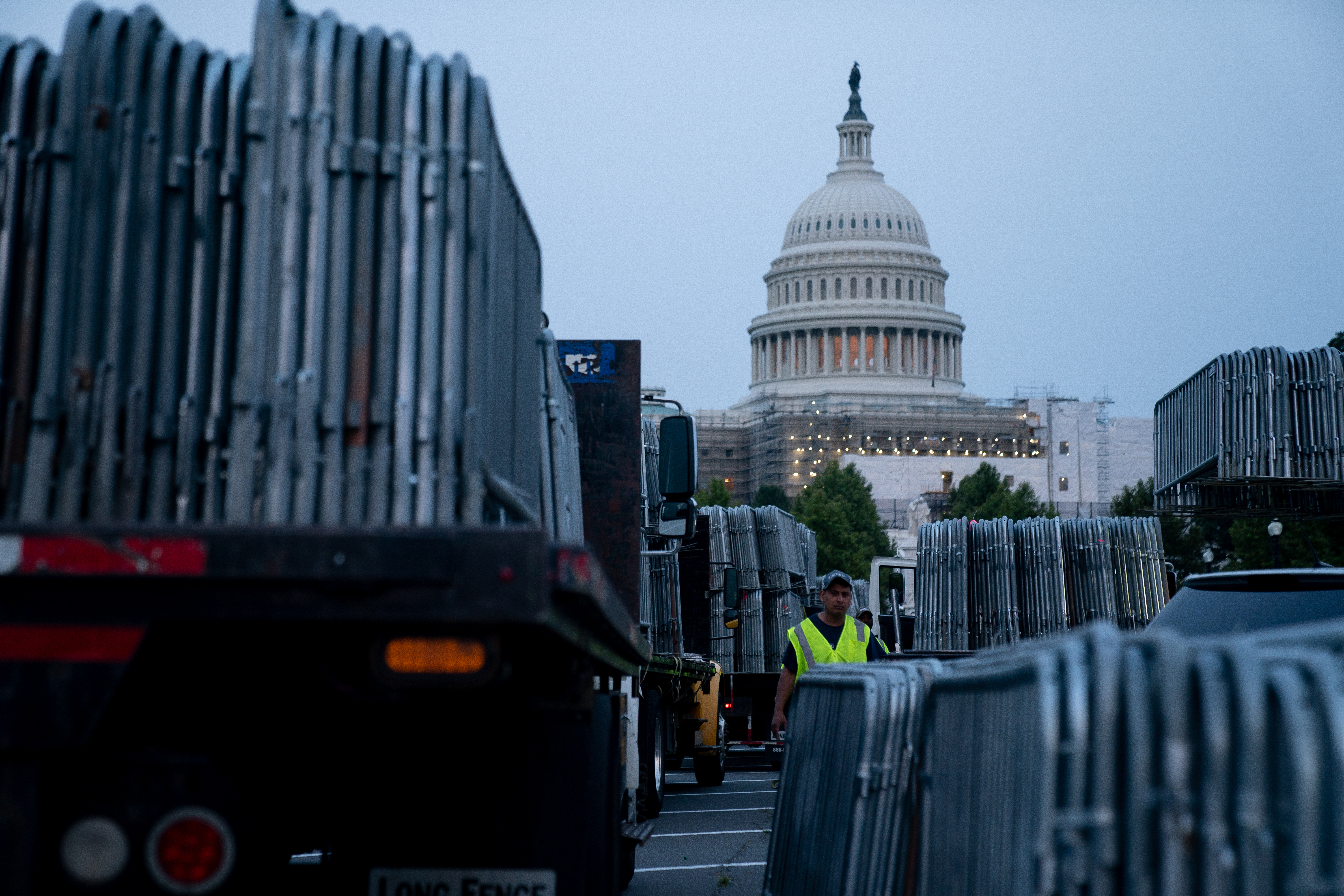 Workers set up security barricades outside the US Capitol