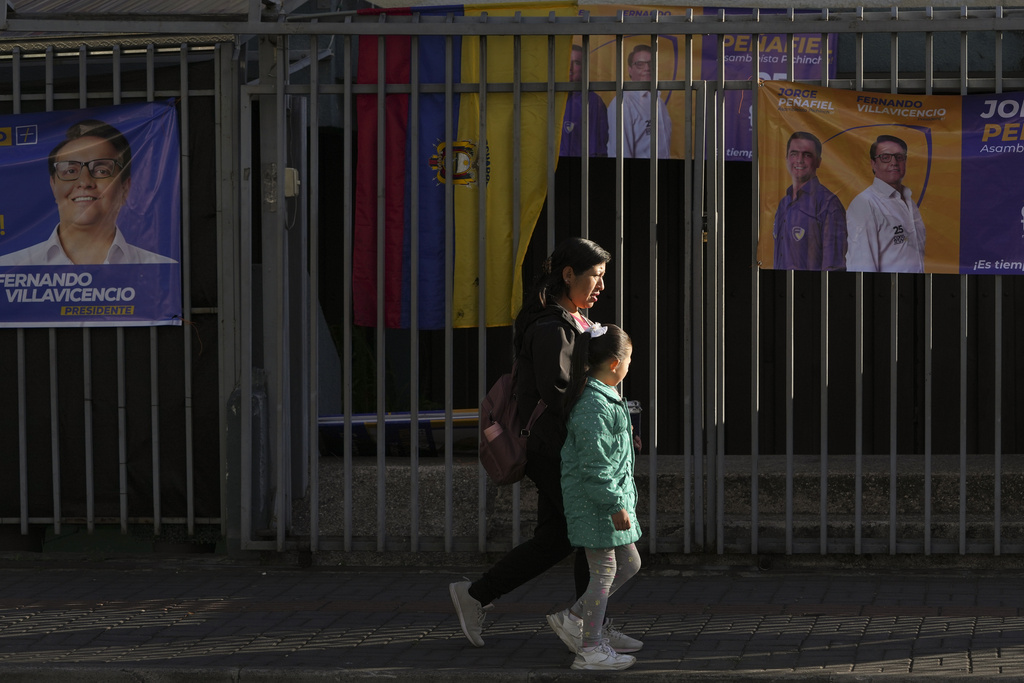Pedestrians walk past the school where Villacicencio was shot