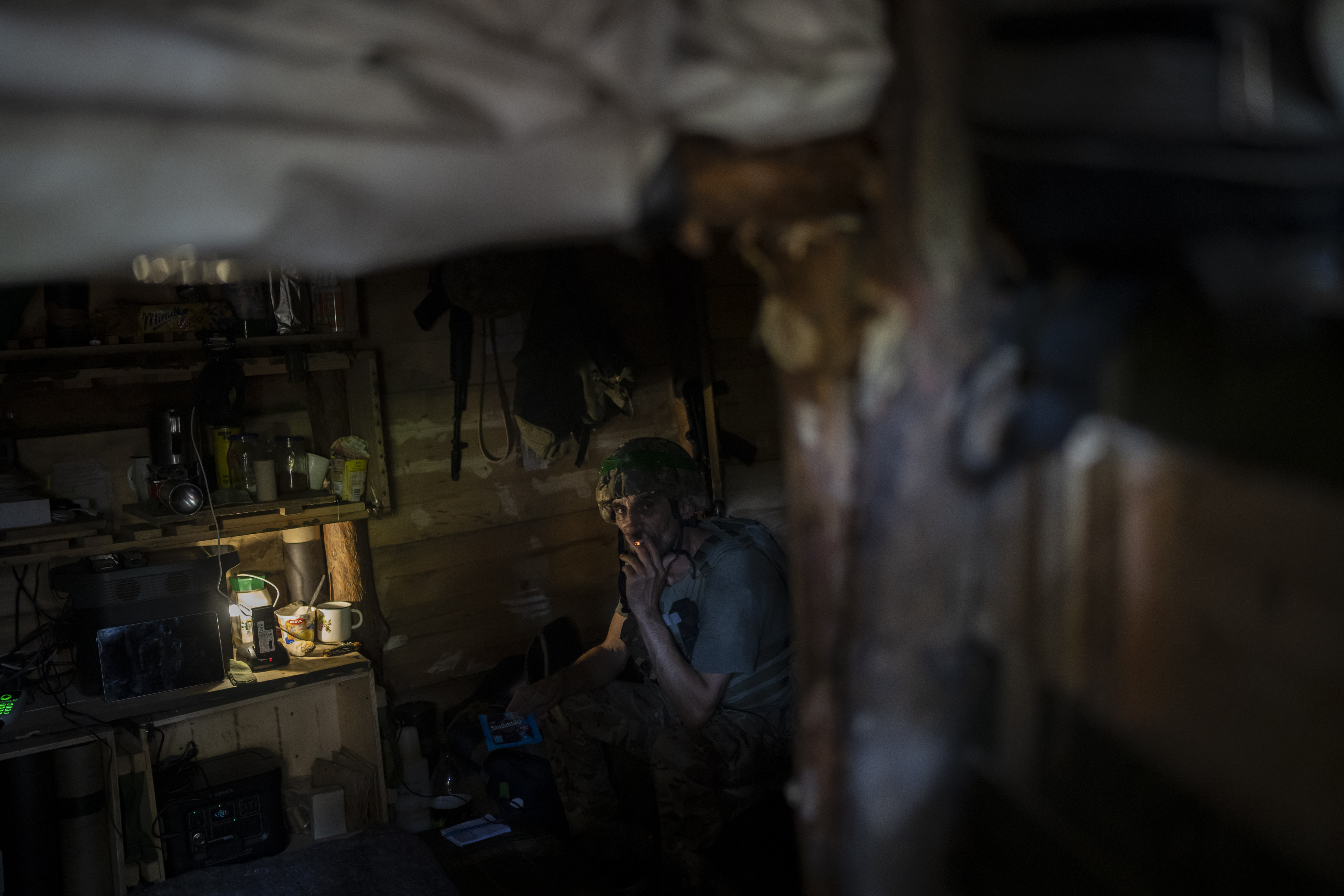 A Ukrainian soldier inside a trench on the outskirts of Kreminna.