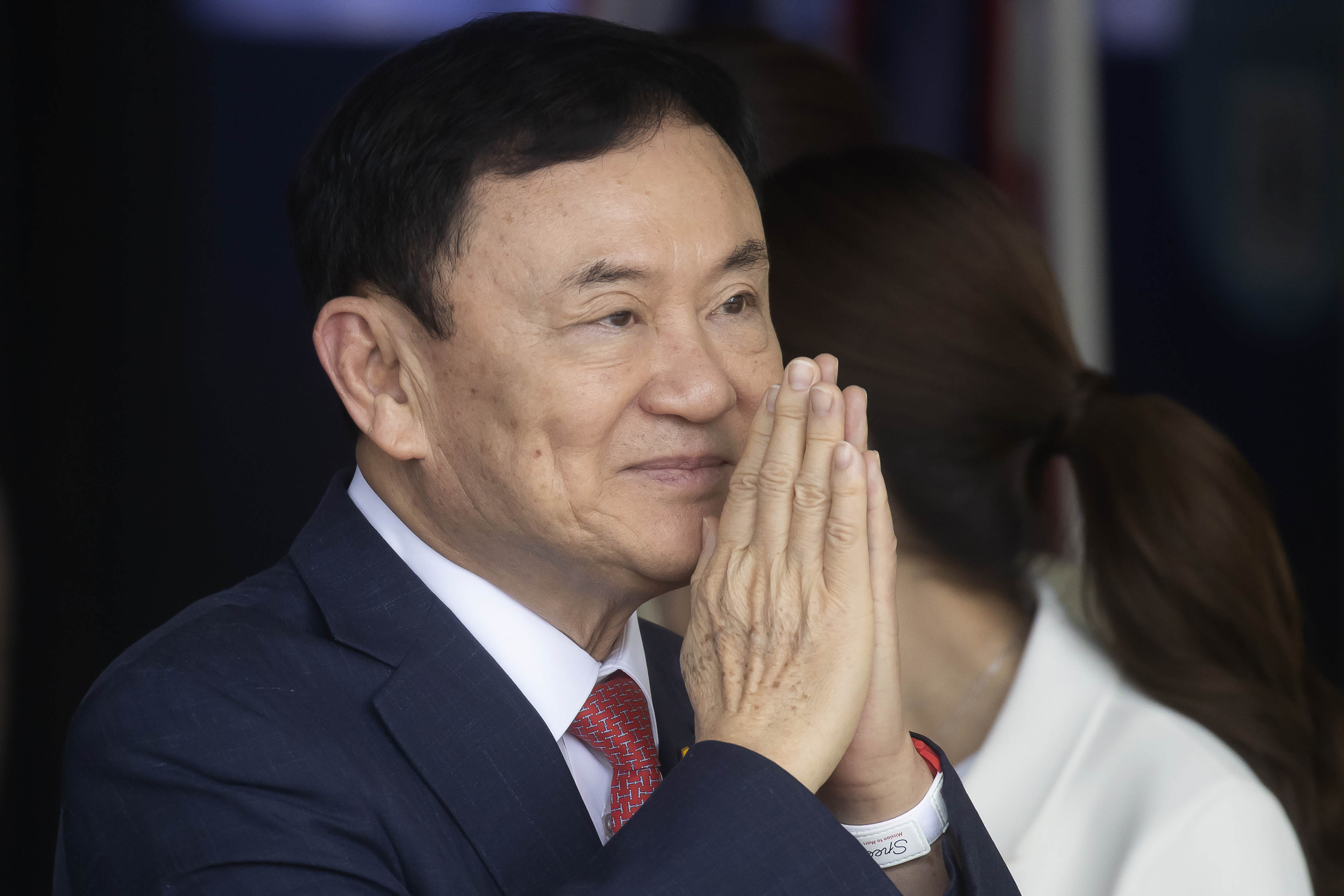 Thaksin Shinawatra makes the wai gesture as he returns to Thailand