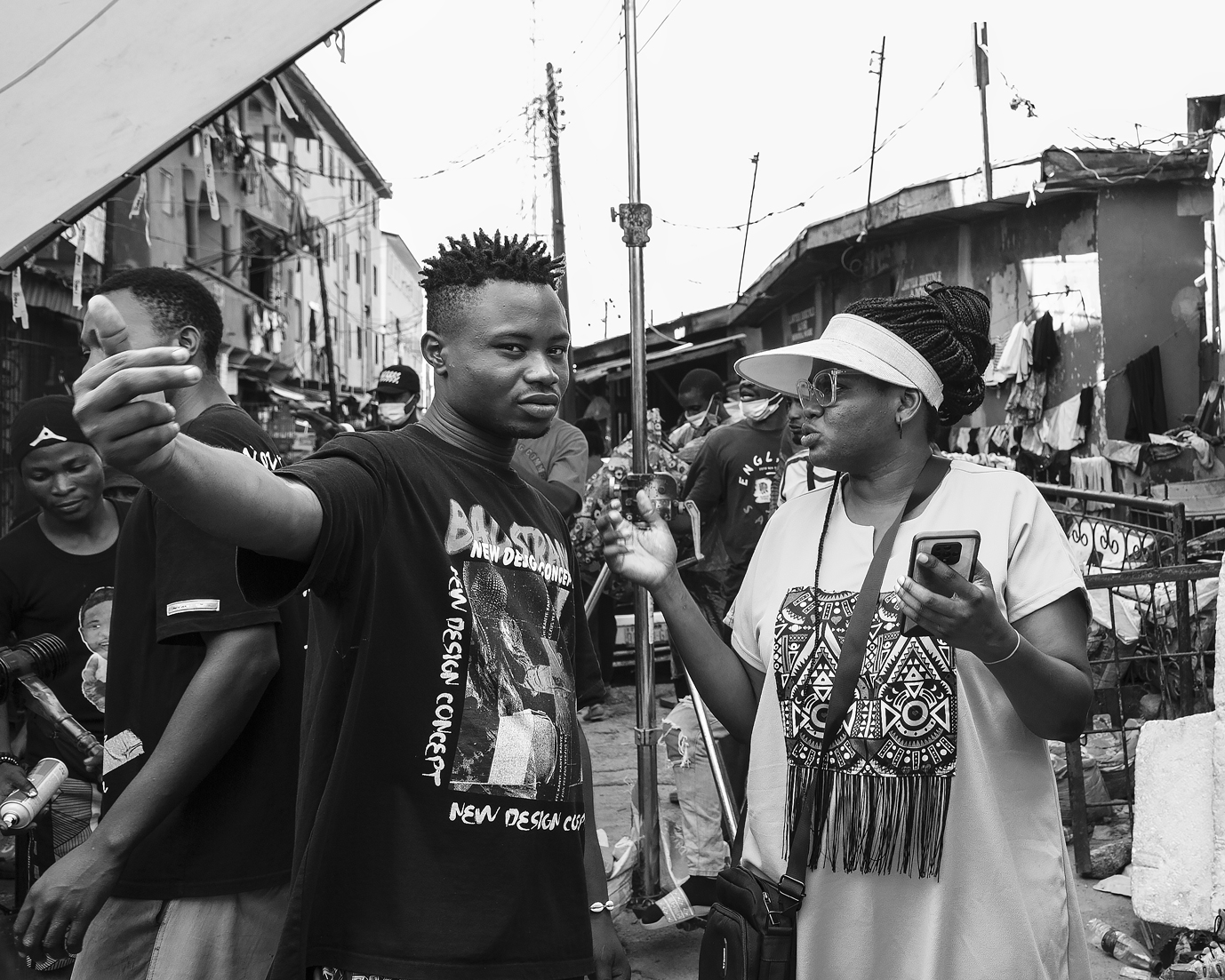 Jade Osiberu (right) discusses with a crew member on set of Gangs of Lagos