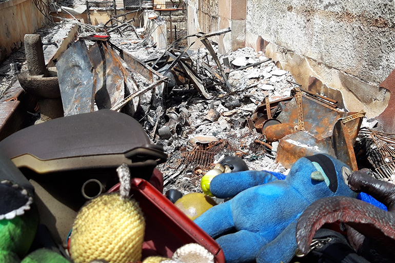 A photo of a building's remains after a fire.