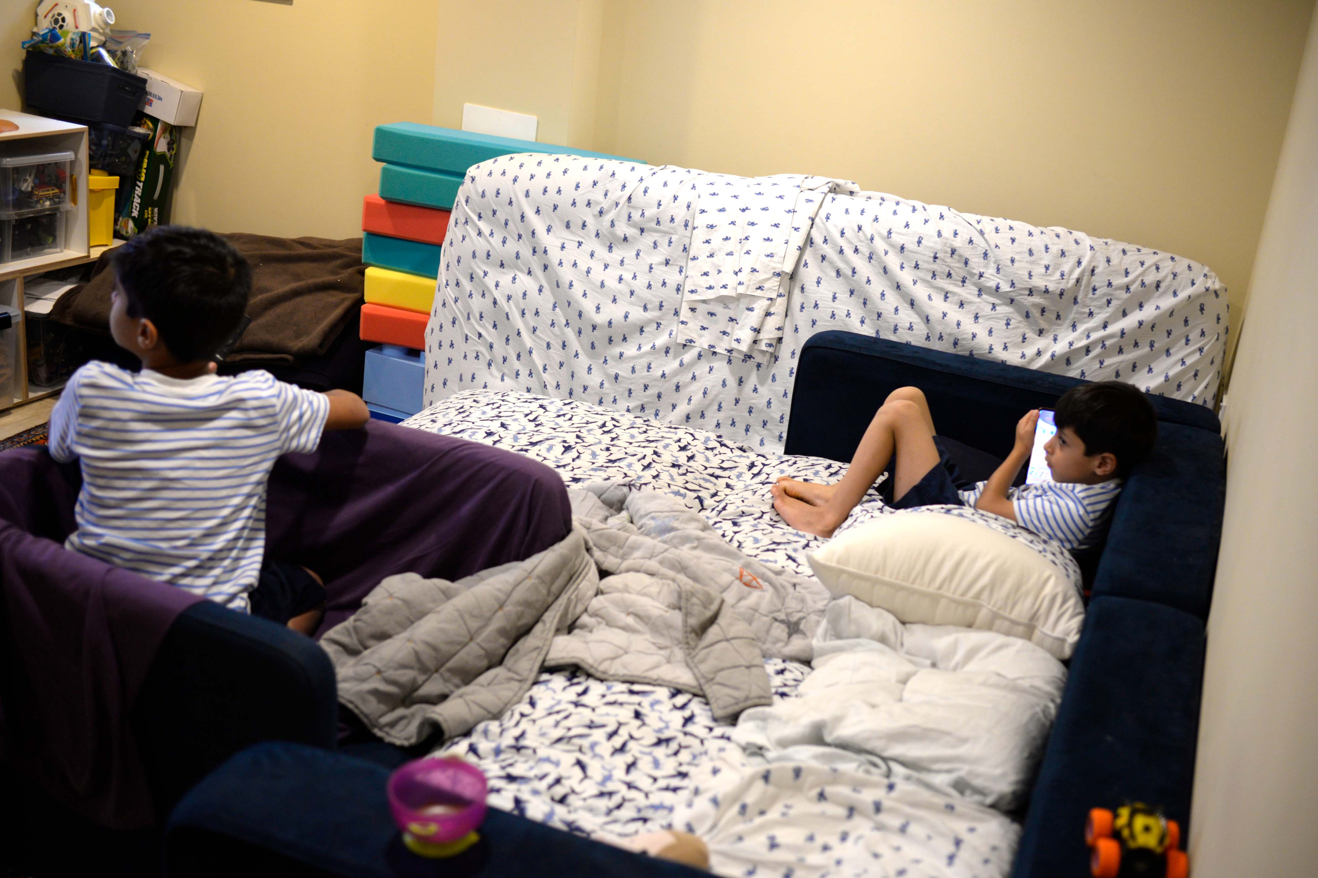 Two Afghan boys the US with their family via the US border are seen in the basement they share with thir family of six 