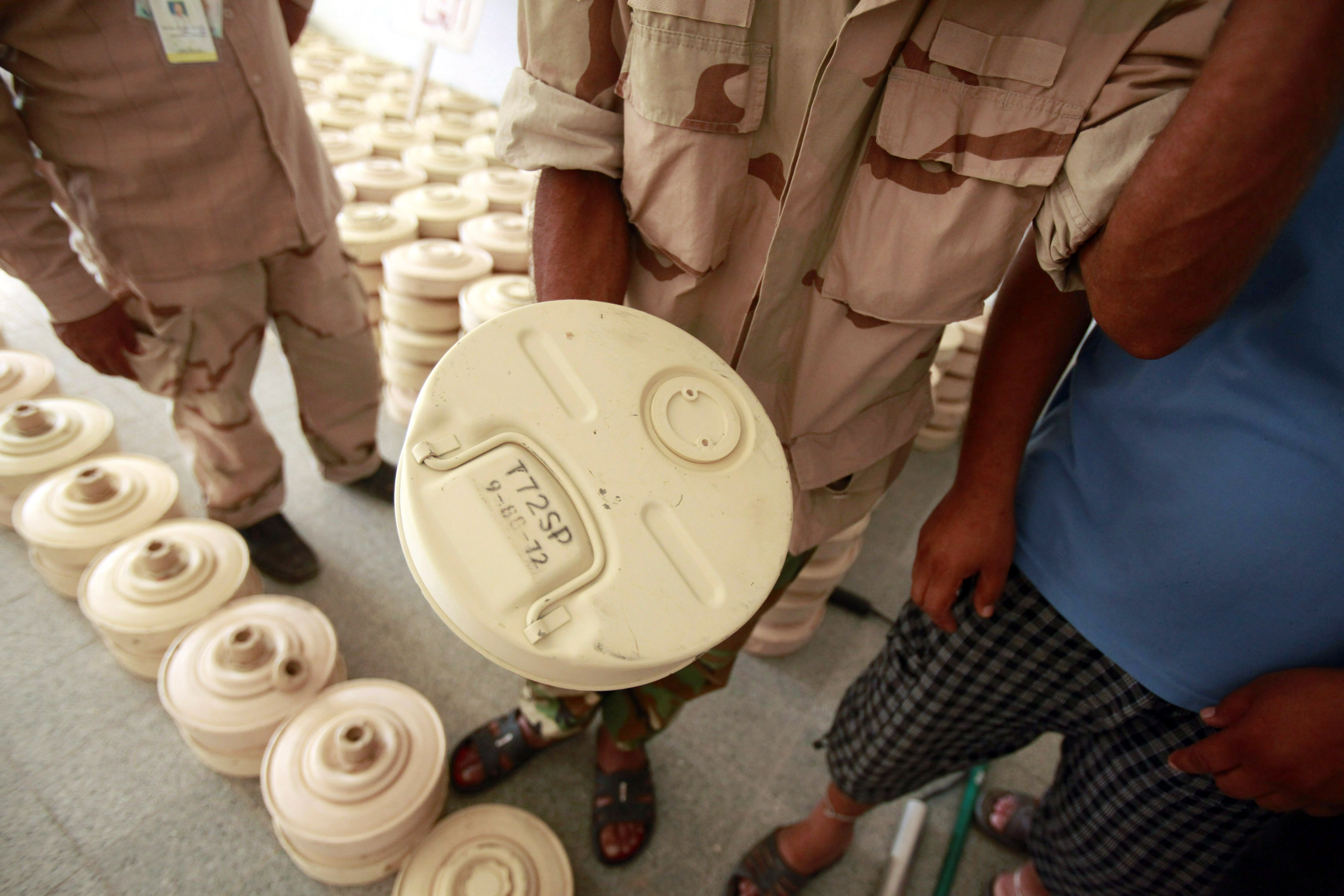 An anti-Gaddafi fighter shows an anti-tank mine defused by the group in Brega September 11, 2011. Volunteers from anti-Gaddafi forces and army soldiers are still searching for mines and unexploded devices in and around Brega, laid by pro-Gaddafi forces during clashes in the last few months. REUTERS/Asmaa Waguih (LIBYA - Tags: CONFLICT MILITARY)