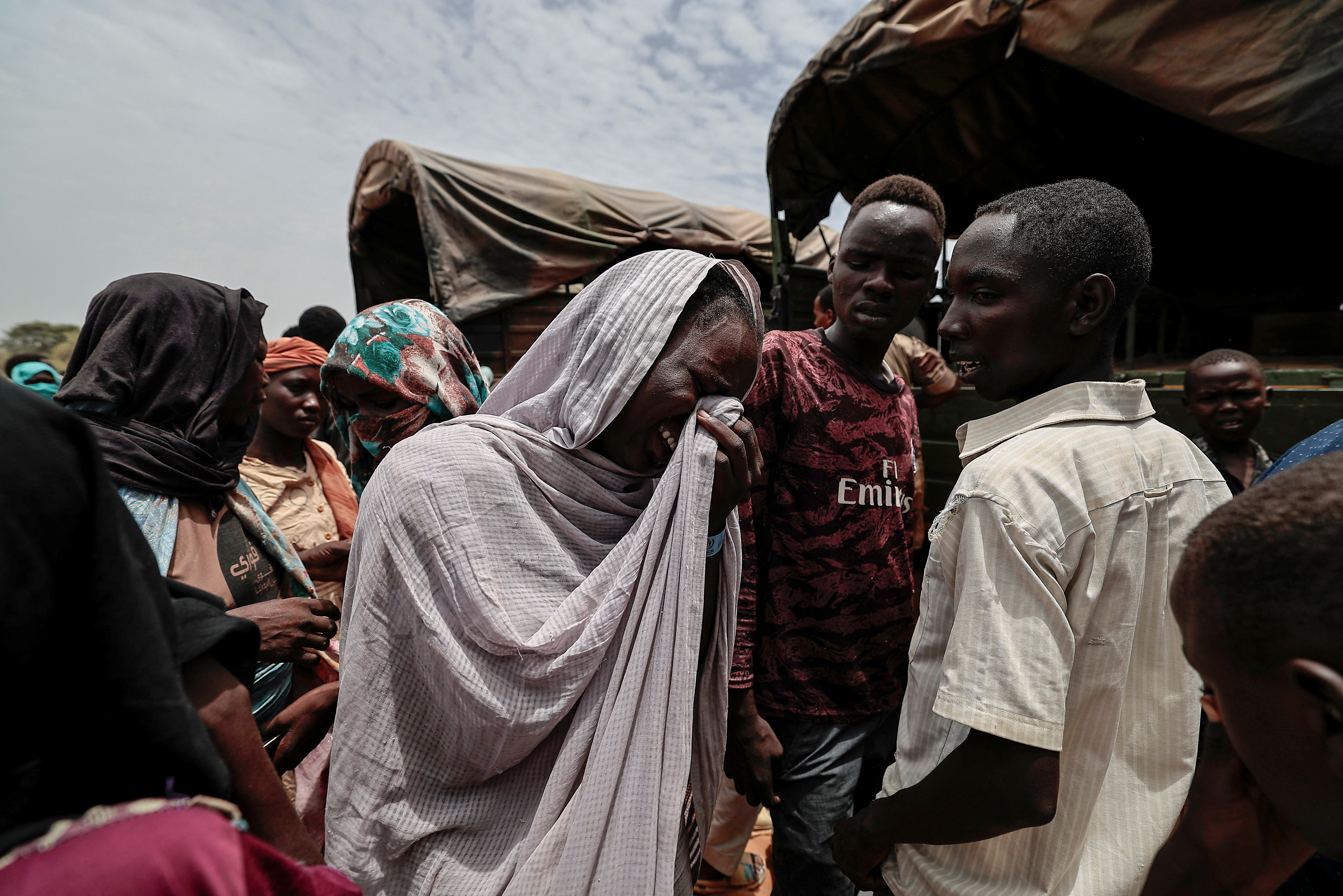 A Sudanese woman, who fled the conflict in Geneina in Sudan's Darfur region, mourns her relative who according to her, was killed by Rapid Support Forces (RSF) relocation from makeshift shelters to refugee camp in Ourang on the outskirts of Adre, Chad July 25, 2023 [File:Zohra Bensemra/Reuters] 
