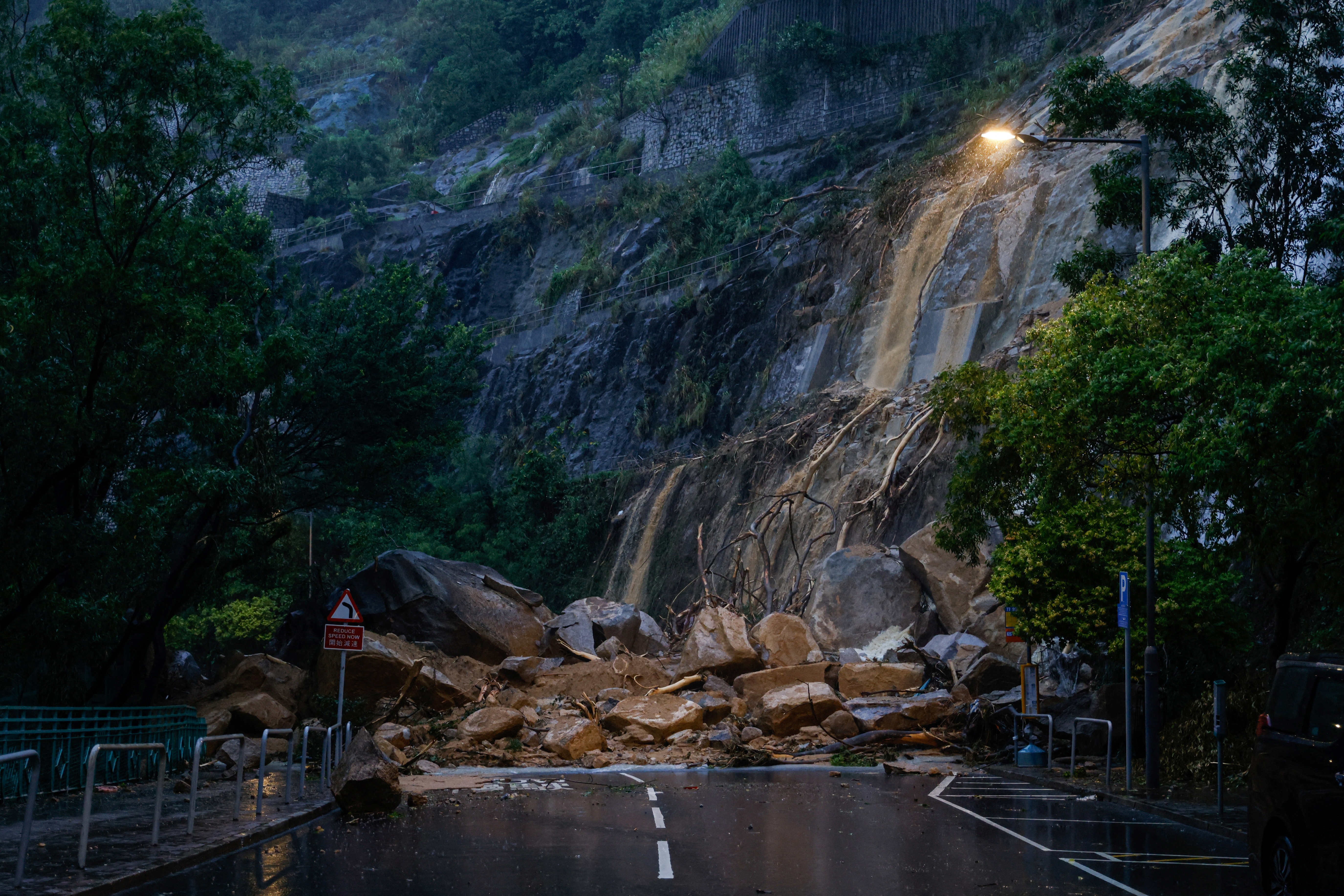 A view of a road blocked due to the debris of a landside after heavy rains, in Hong Kong