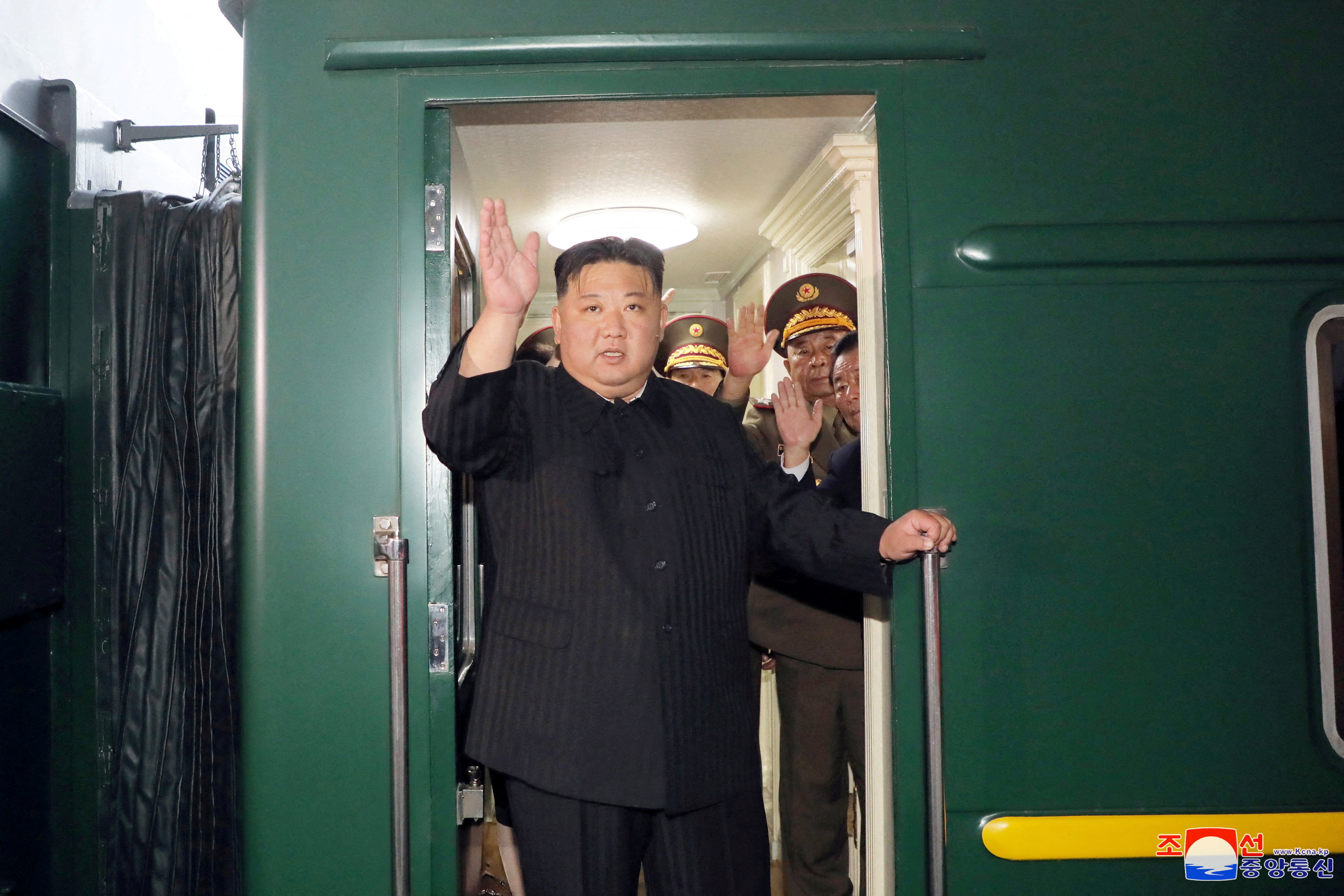 Kim waving as he boards his train in Pyongyang