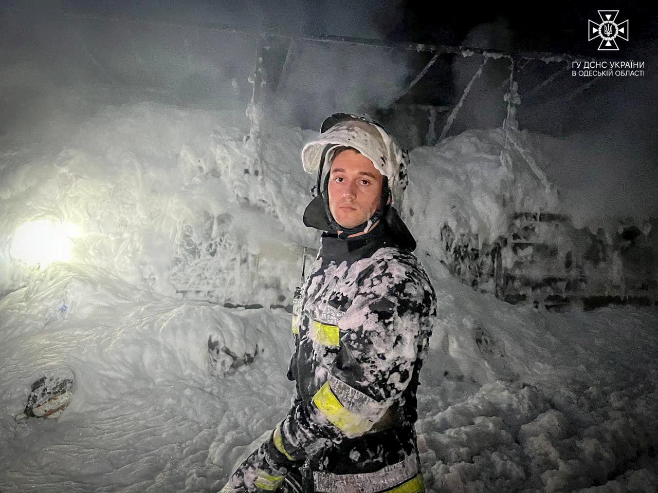 A firefighter works to extinguish burning trucks damaged during a Russian drone attack, amid Russia's attack on Ukraine, at a compound of a port on Danube river in Odesa region, Ukraine September 26, 2023. Press service of a State Emergency Service of Ukraine in Odesa region/Handout via REUTERS ATTENTION EDITORS - THIS IMAGE HAS BEEN SUPPLIED BY A THIRD PARTY. DO NOT OBSCURE LOGO. MANDATORY CREDIT