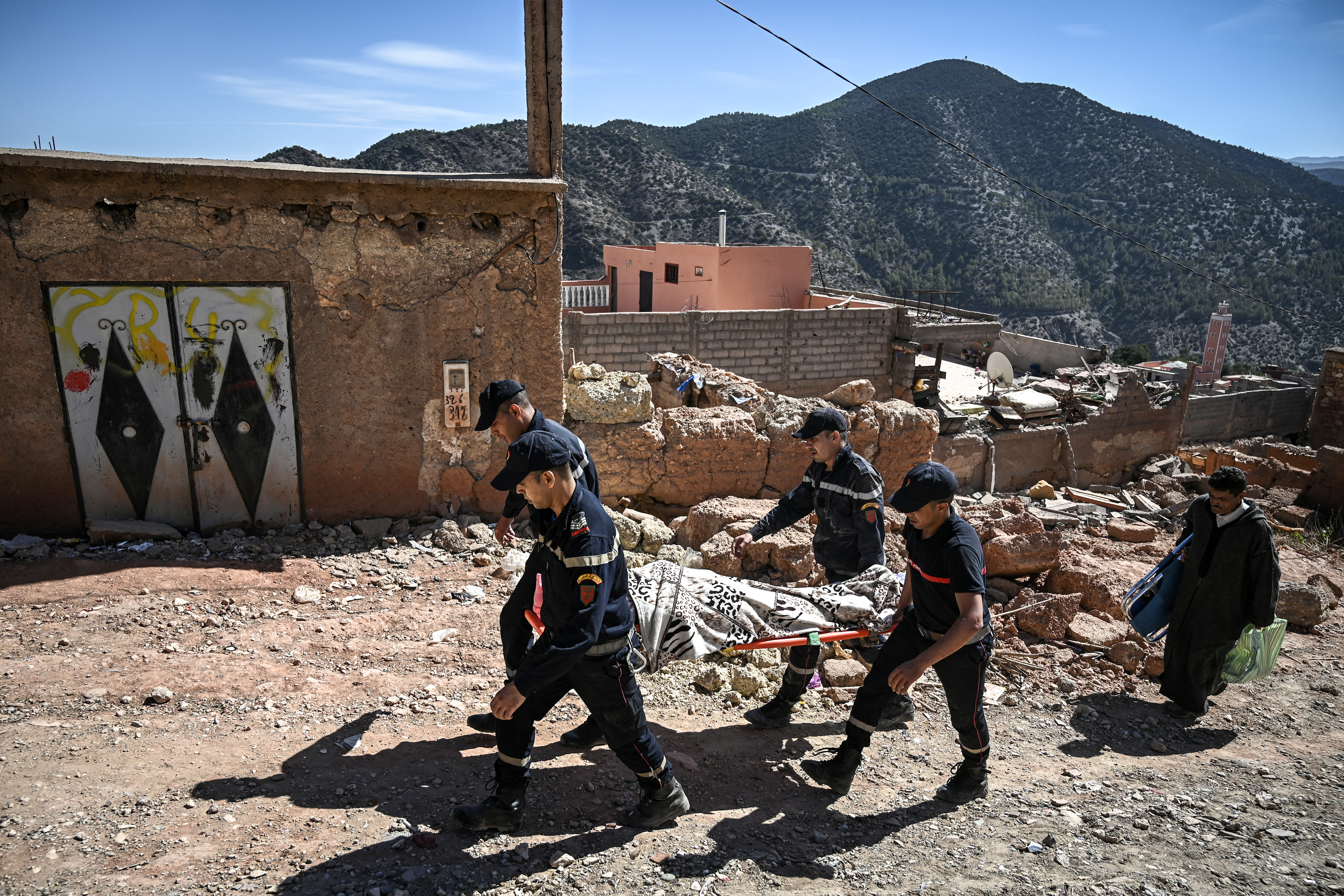 Civil defence responders evacuate an injured survivor