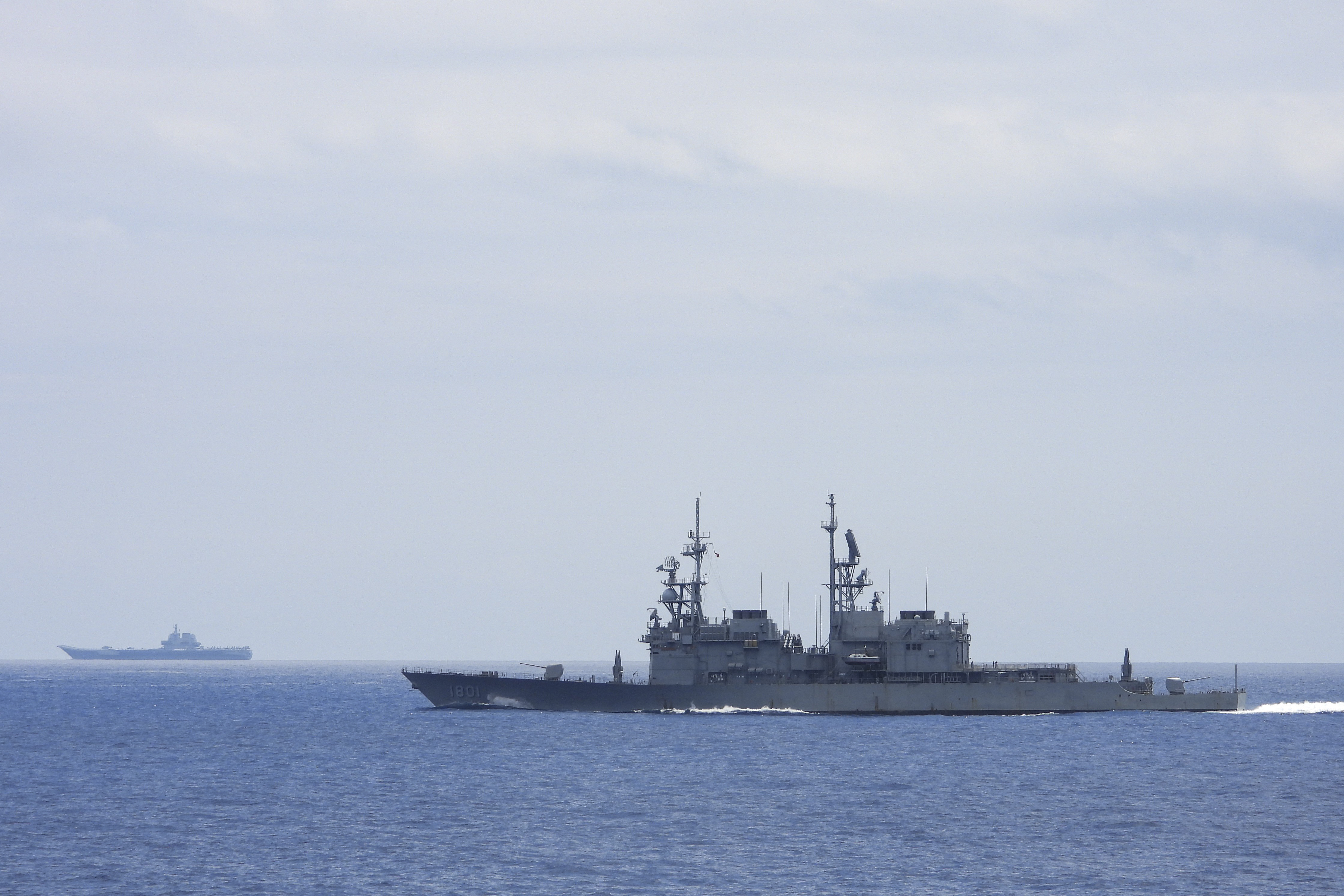 This undated handout photo released by the Taiwan Defense Ministry on September 13, 2023 shows Chinese aircraft carrier Shandong being monitored by a Taiwanese Keelung class warship at sea.
