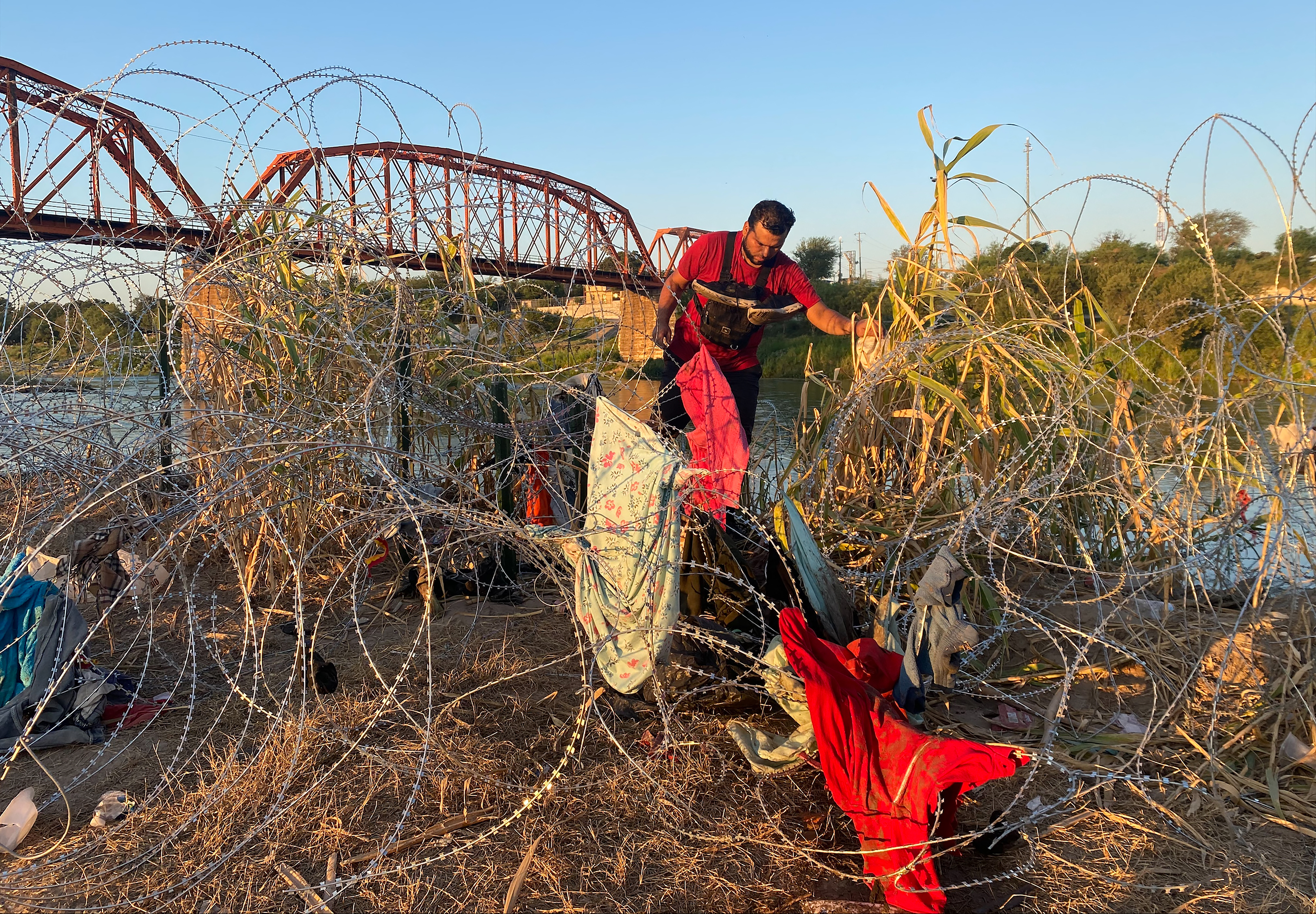 Venezuelan Alejandro Urdaneta, a migrant seeking asylum, crosses the US-Mexico border in Eagle Pass, Texas, early on September 23, 2023.
