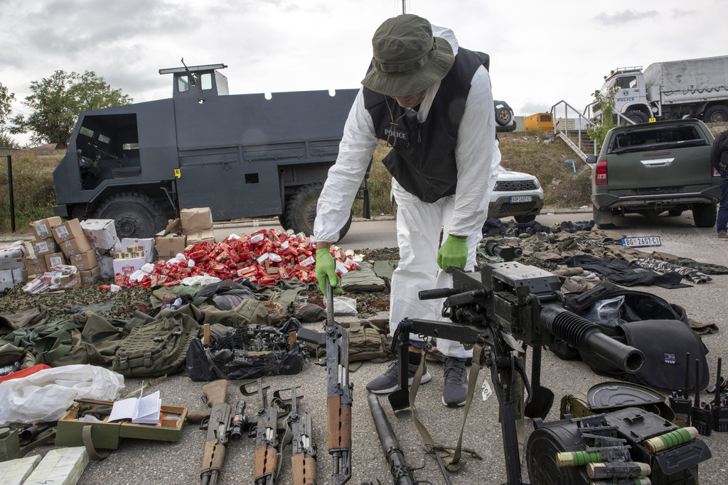 Kosovo police officers display seized weapons and military equipment during the police operation in the village of Banjska displayed in police camp in Mitrovica, Kosovo, Monday, Sept. 25, 2023. Tensions between Serbia and Kosovo flared anew over the weekend when some 30 heavily armed Serbs barricaded themselves in an Orthodox monastery in northern Kosovo, setting off a daylong gunbattle with police that left one officer and three attackers dead. (AP Photo/Visar Kryeziu)