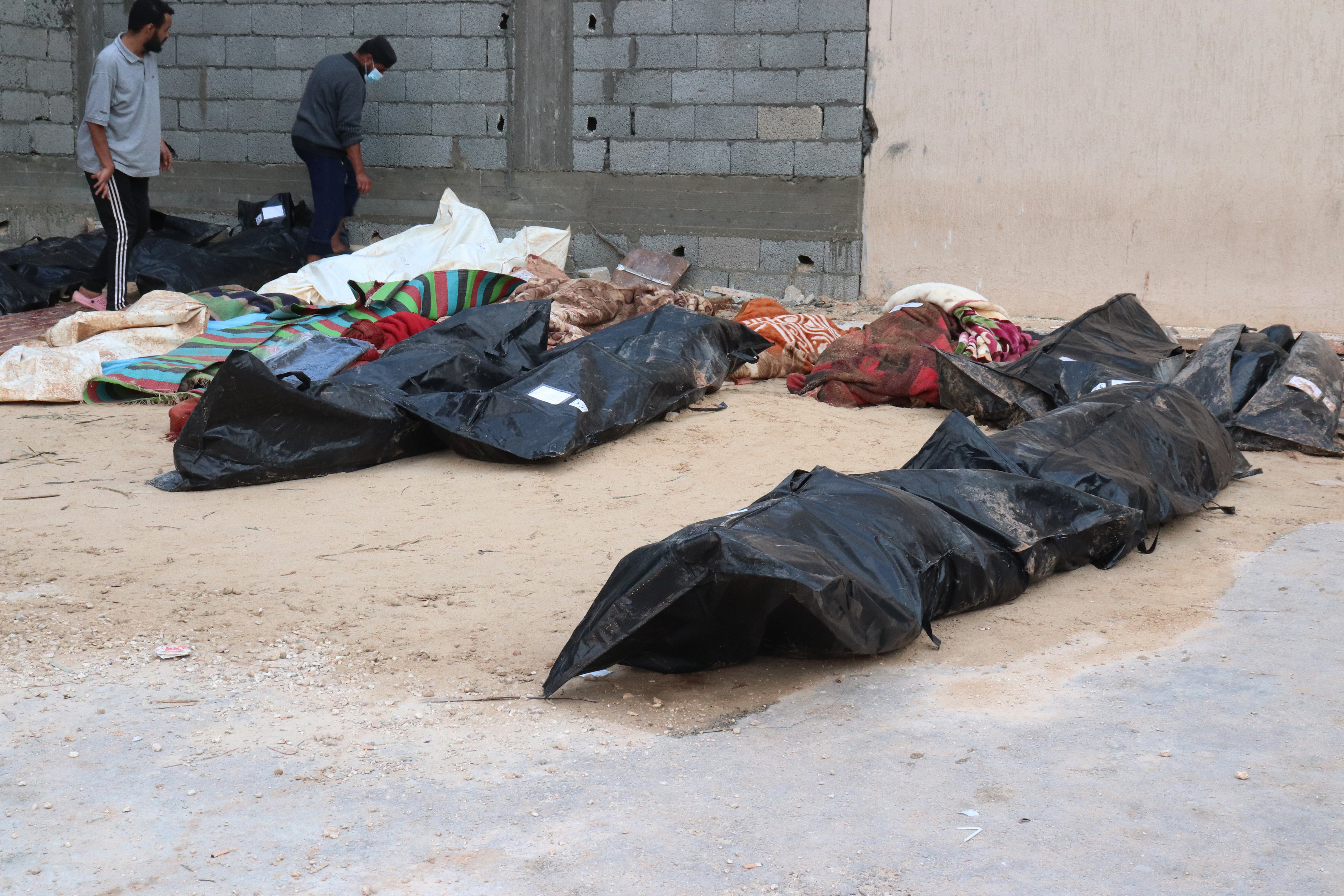 DERNA, LIBYA - SEPTEMBER 12: People who lost their lives are covered by plastic bag after the floods caused by the Storm Daniel ravaged disaster zones in Derna, Libya on September 12, 2023. The death toll from devastating floods in Libya's eastern city of Derna has risen to 5,300 and thousands of people are still missing, the country's official news agency reported on Tuesday. (Photo by Abdullah Mohammed Bonja/Anadolu Agency via Getty Images)