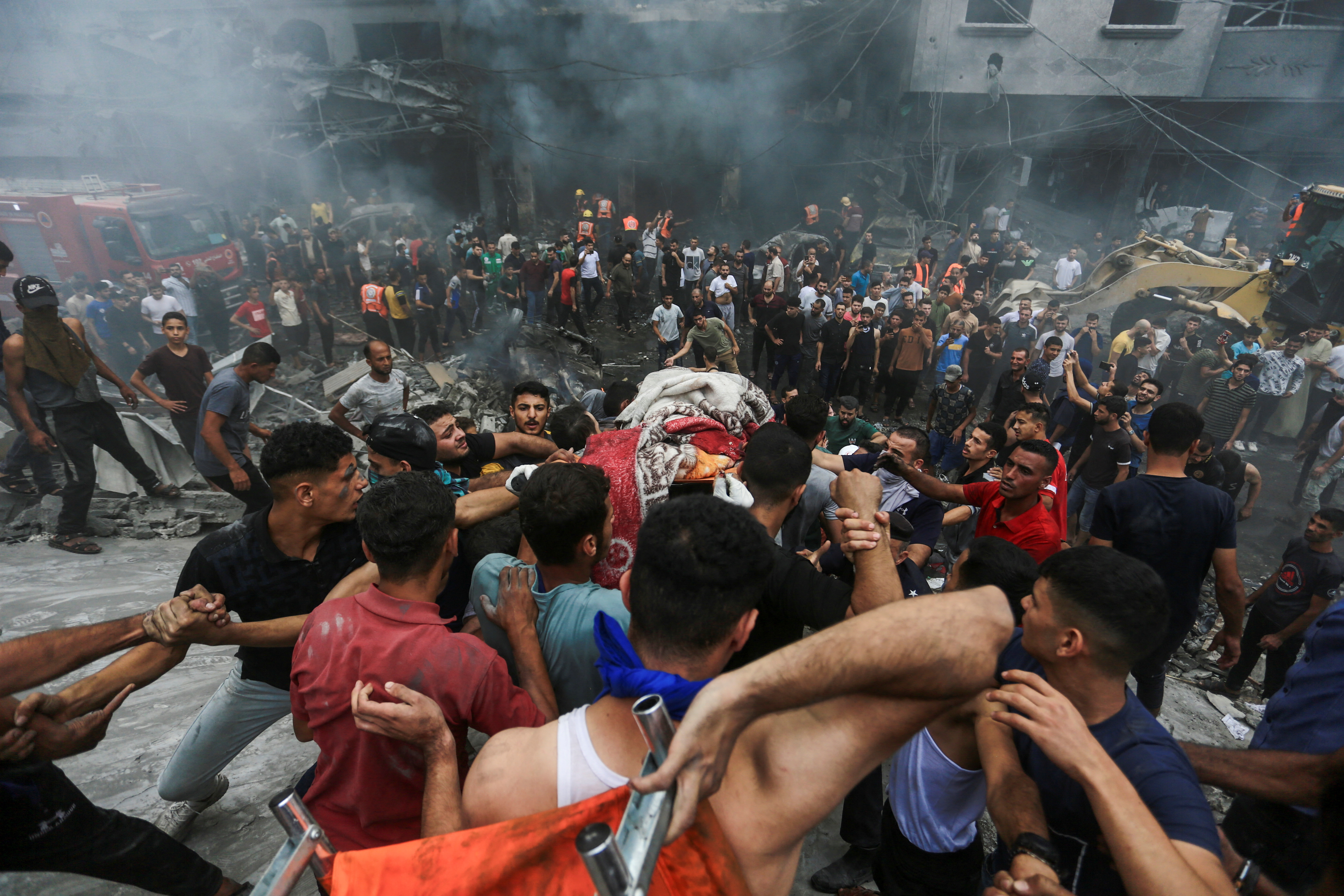 People carry the body of a Palestinian killed in Israeli strikes, in Jabalia refugee camp, in the northern Gaza Strip