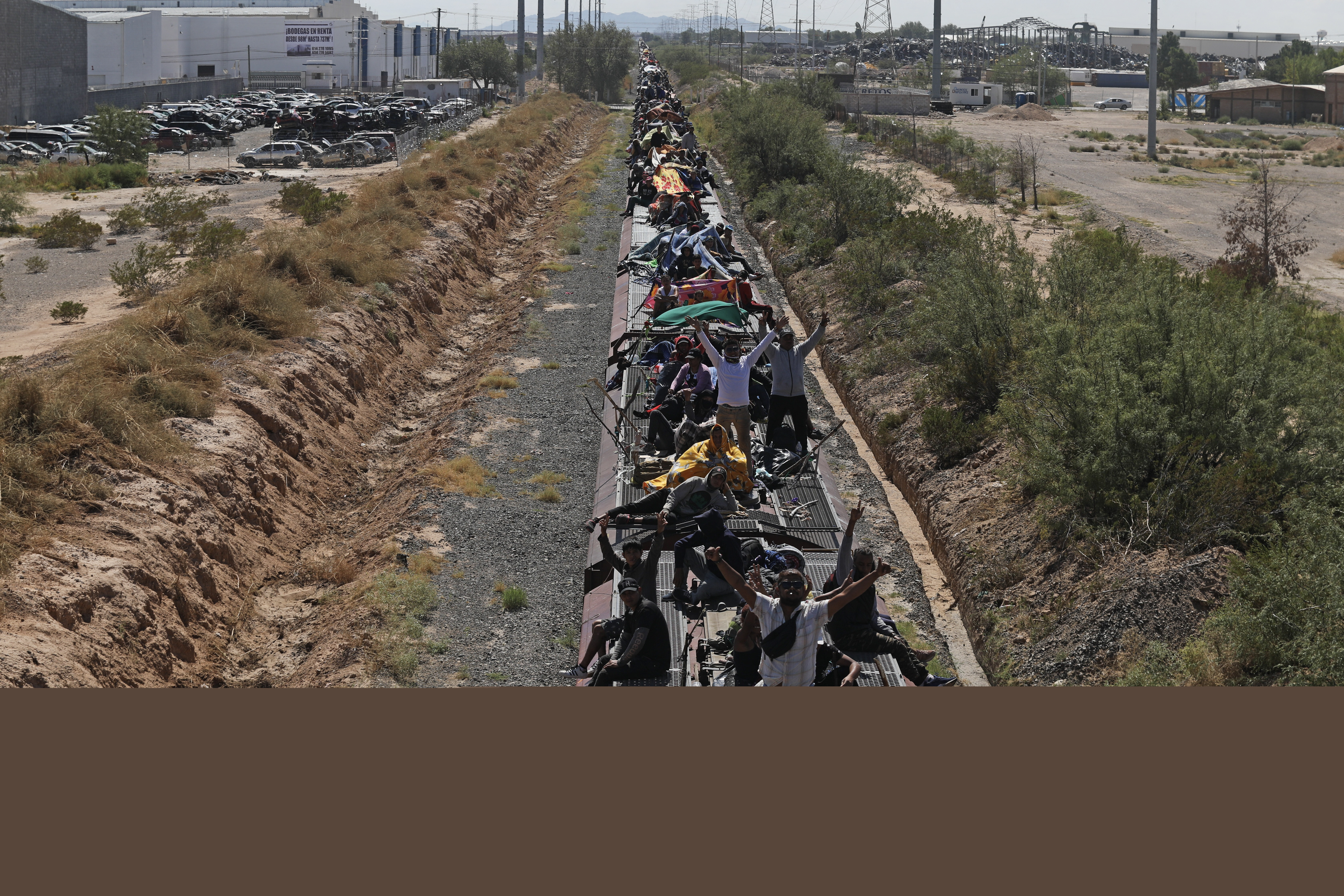 Migrant people, mostly from Venezuela, travel on the wagons of a goods train to Ciudad Juarez,