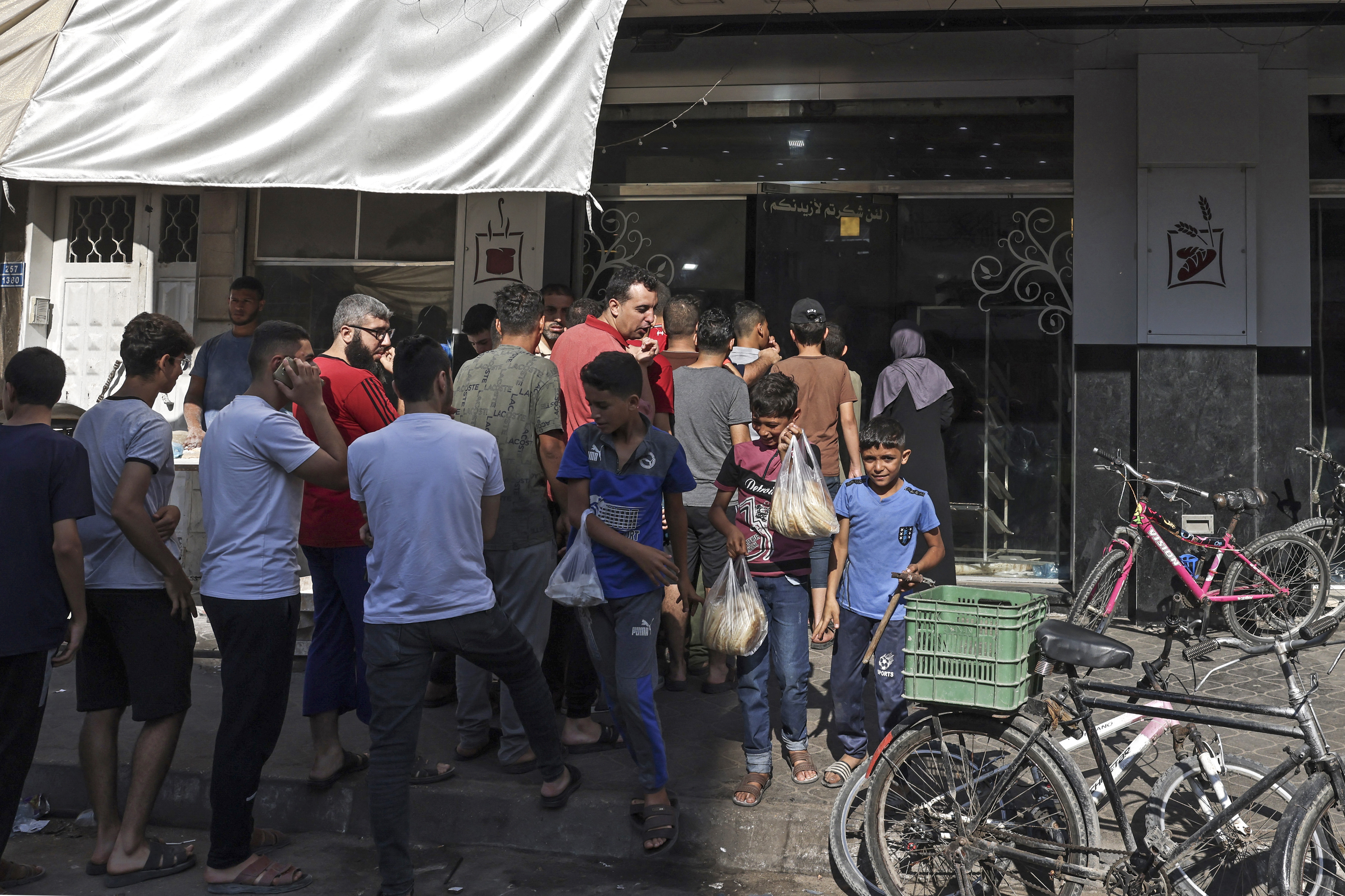 People queue outside a bakery in Gaza City