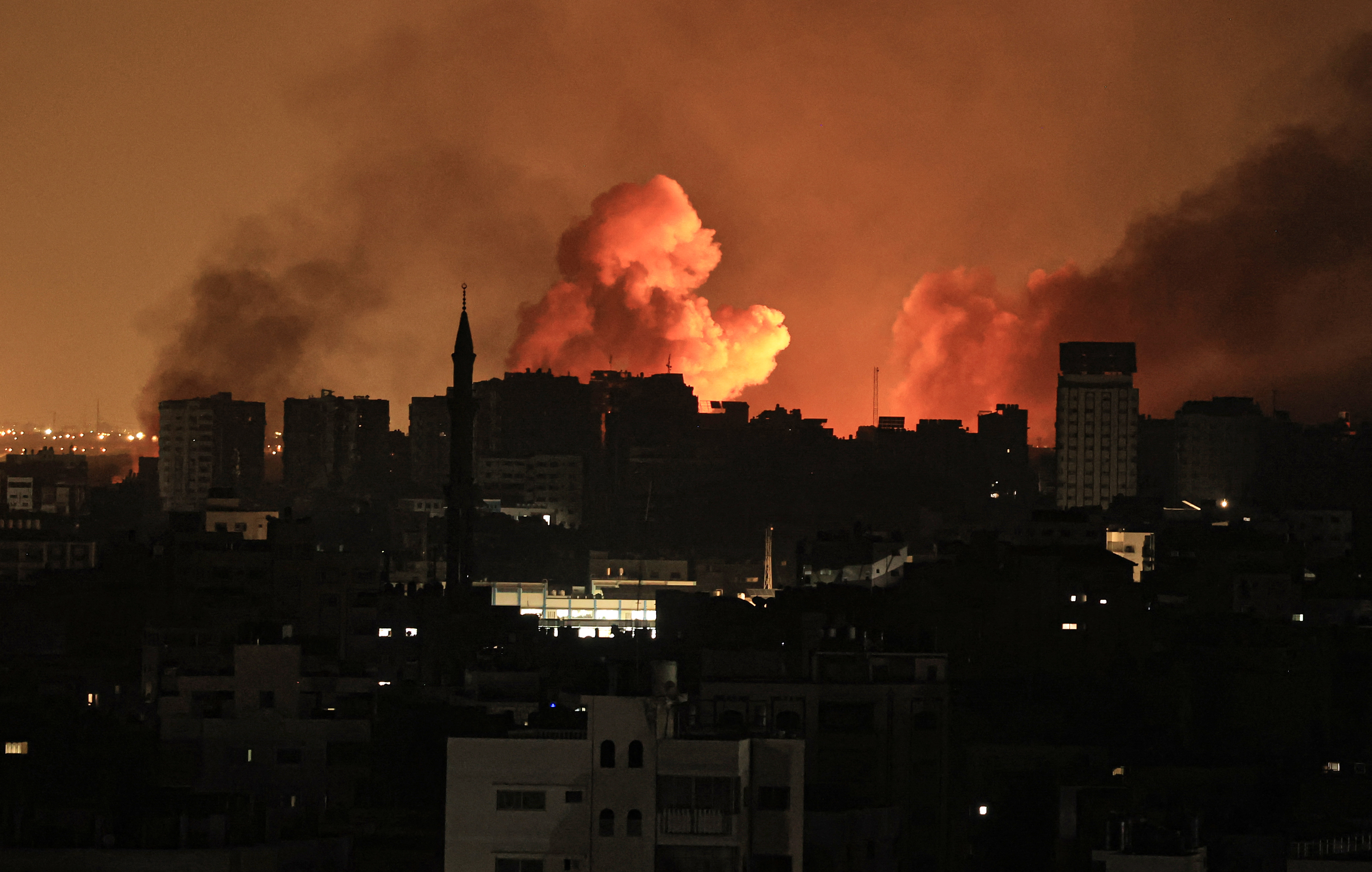 A ball of fire erupts in Gaza City after an Israeli air strike on October 12, 2023.