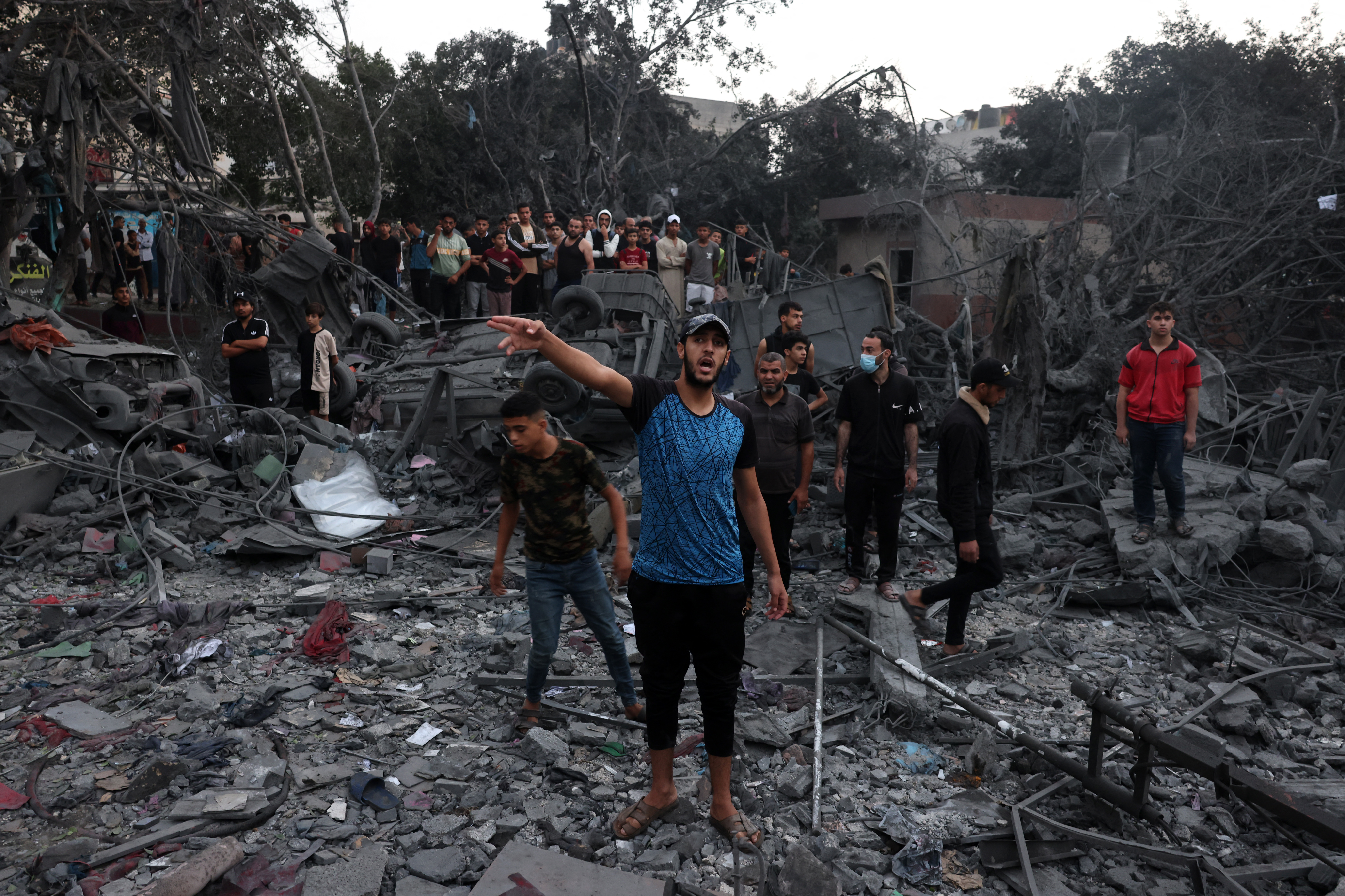 Palestinians search the rubble of a building following overnight Israeli strikes on the Rafah refugee camp in the southern Gaza Strip