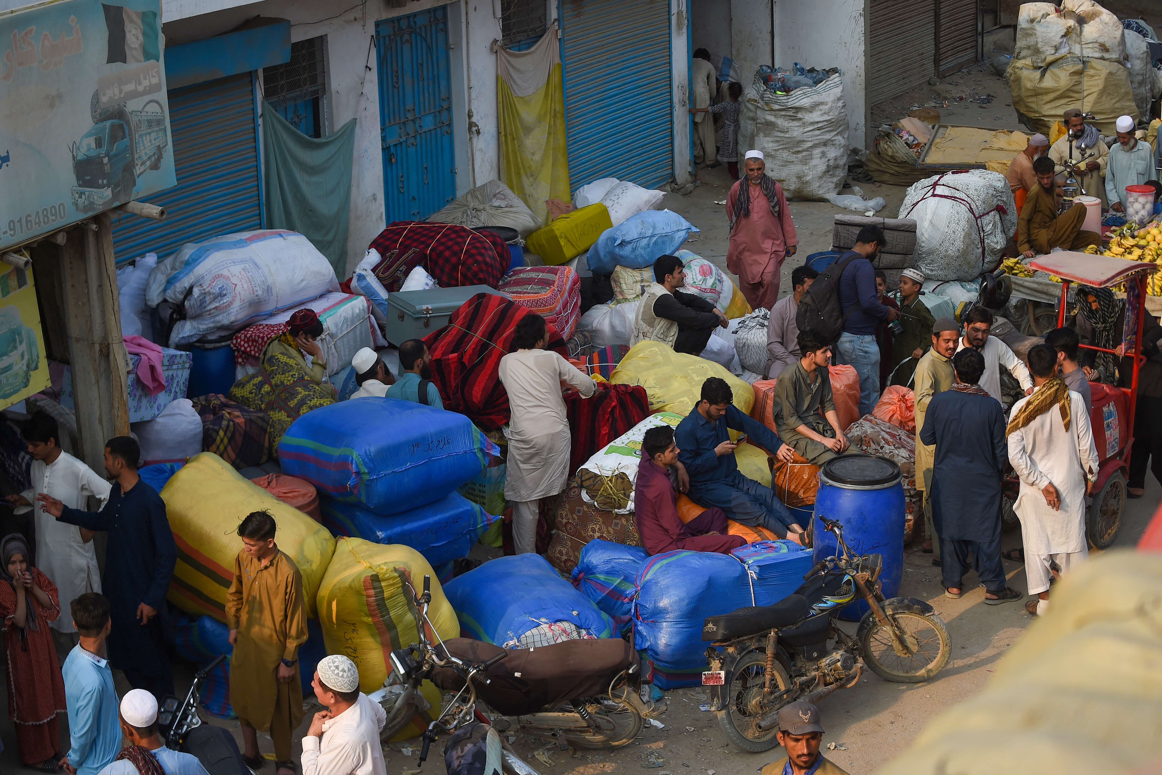 Afghan refugees depart for Afghanistan from the Karachi bus terminal