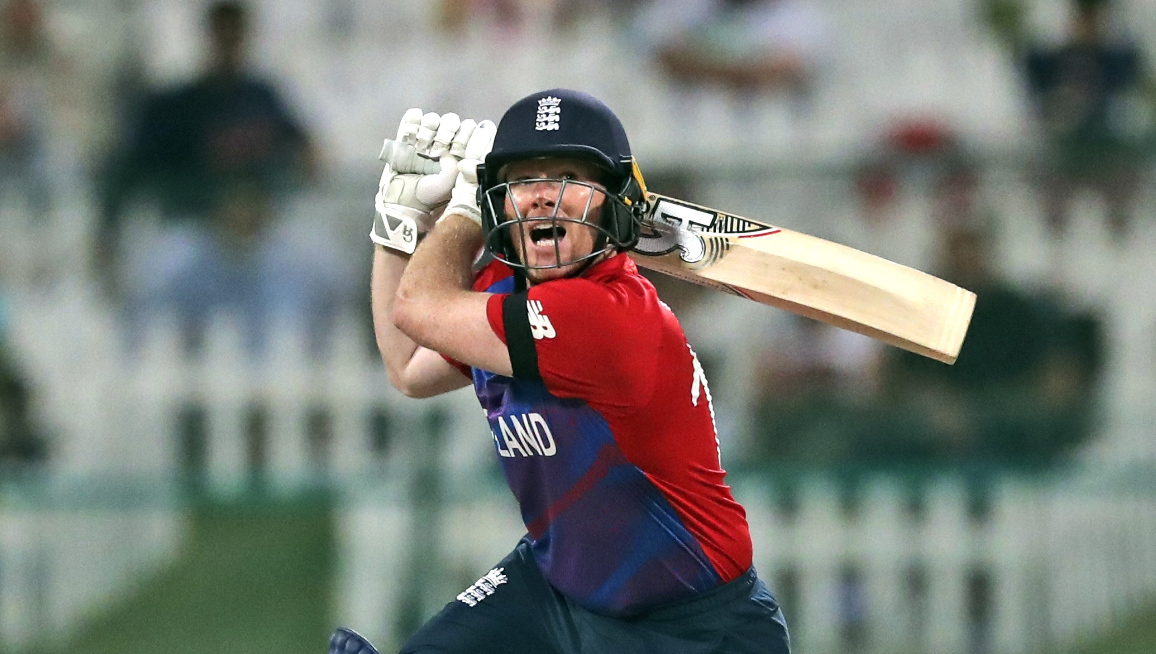 Eoin Morgan swings a cricket bat behind his head during a match
