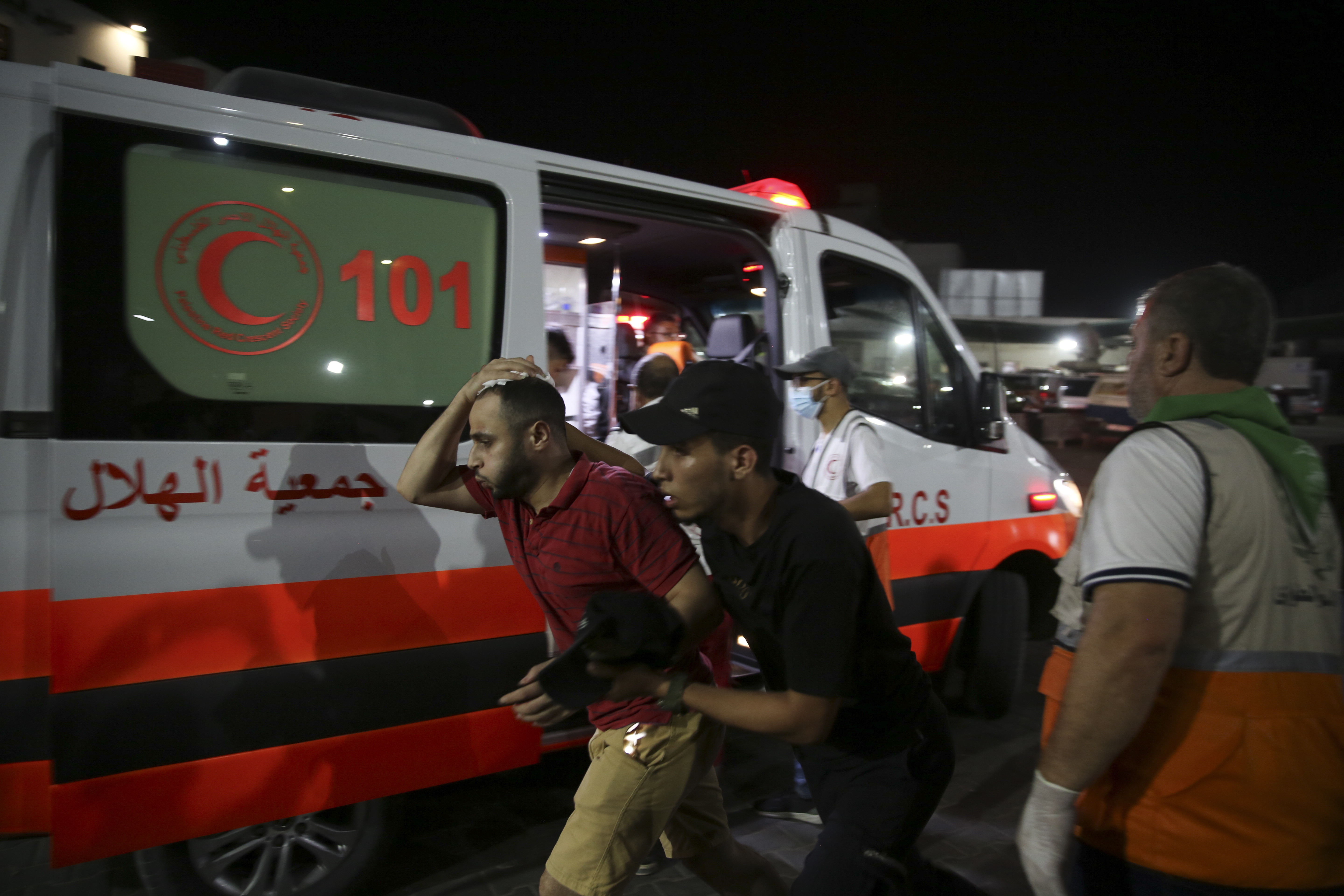 Palestinian medics help a man wounded in Israeli strikes to in Shifa Hospital in Gaza City, Friday, Oct. 13, 2023.