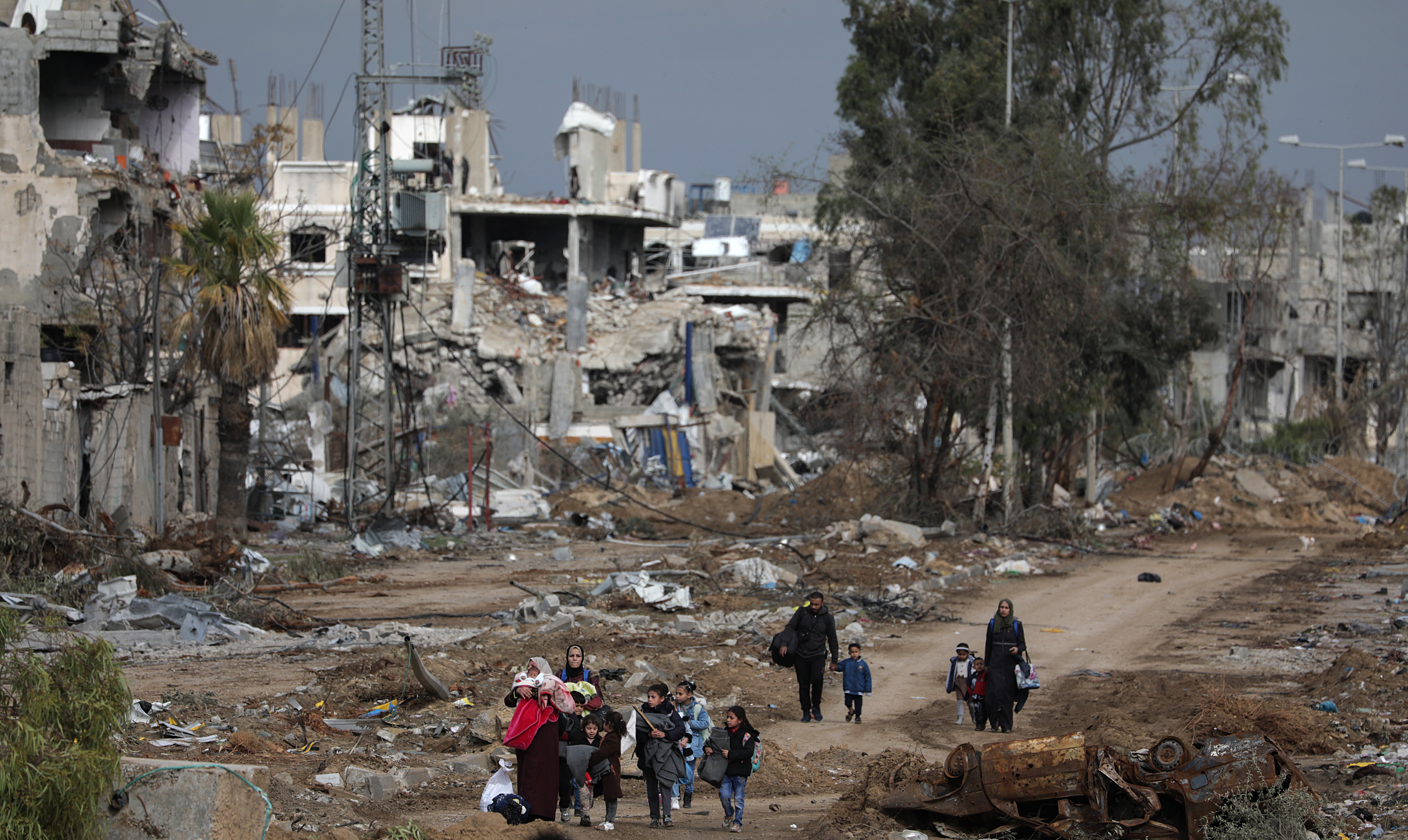 Palestinians walk after crossing from the northern Gaza Strip to the southern Gaza Strip along Salah Al Din road in the central Gaza Strip.