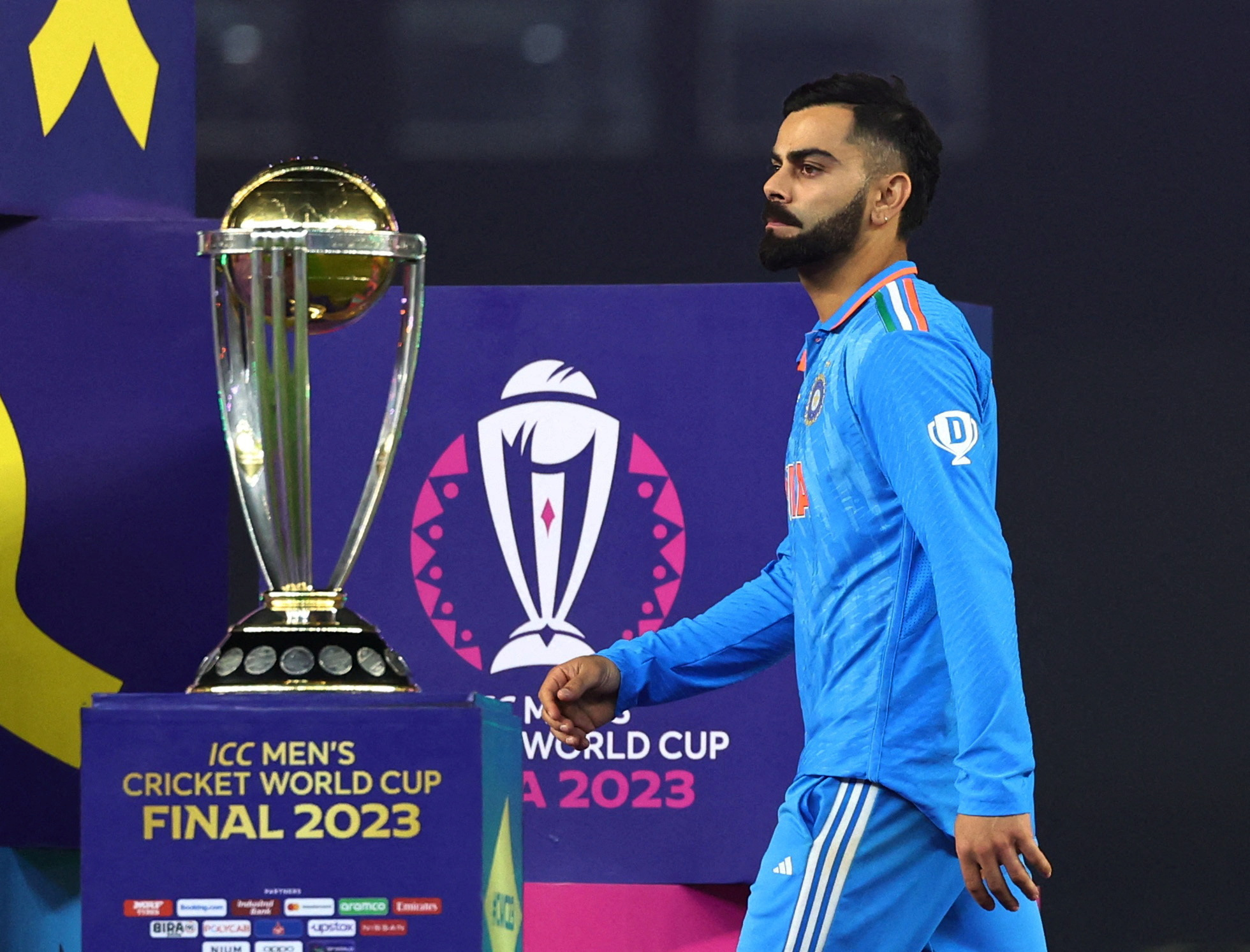 Cricket - ICC Cricket World Cup 2023 - Final - India v Australia - Narendra Modi Stadium, Ahmedabad, India - November 19, 2023 India's Virat Kohli looks dejected as he walks past the ICC Cricket World Cup trophy during the medal ceremony REUTERS/Andrew Boyers TPX IMAGES OF THE DAY