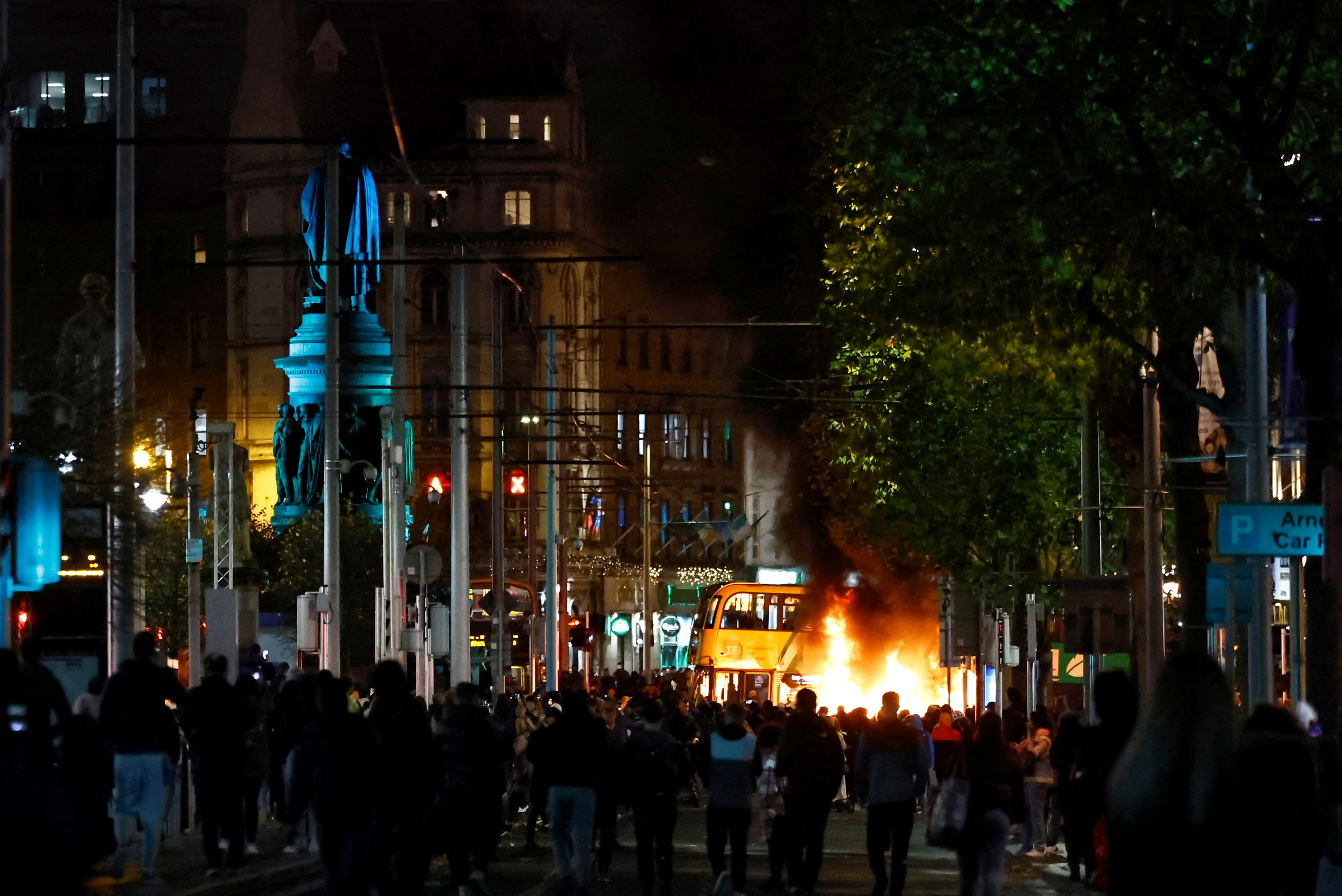 A bus burns during a demonstration following a suspected stabbing that left few children injured in Dublin