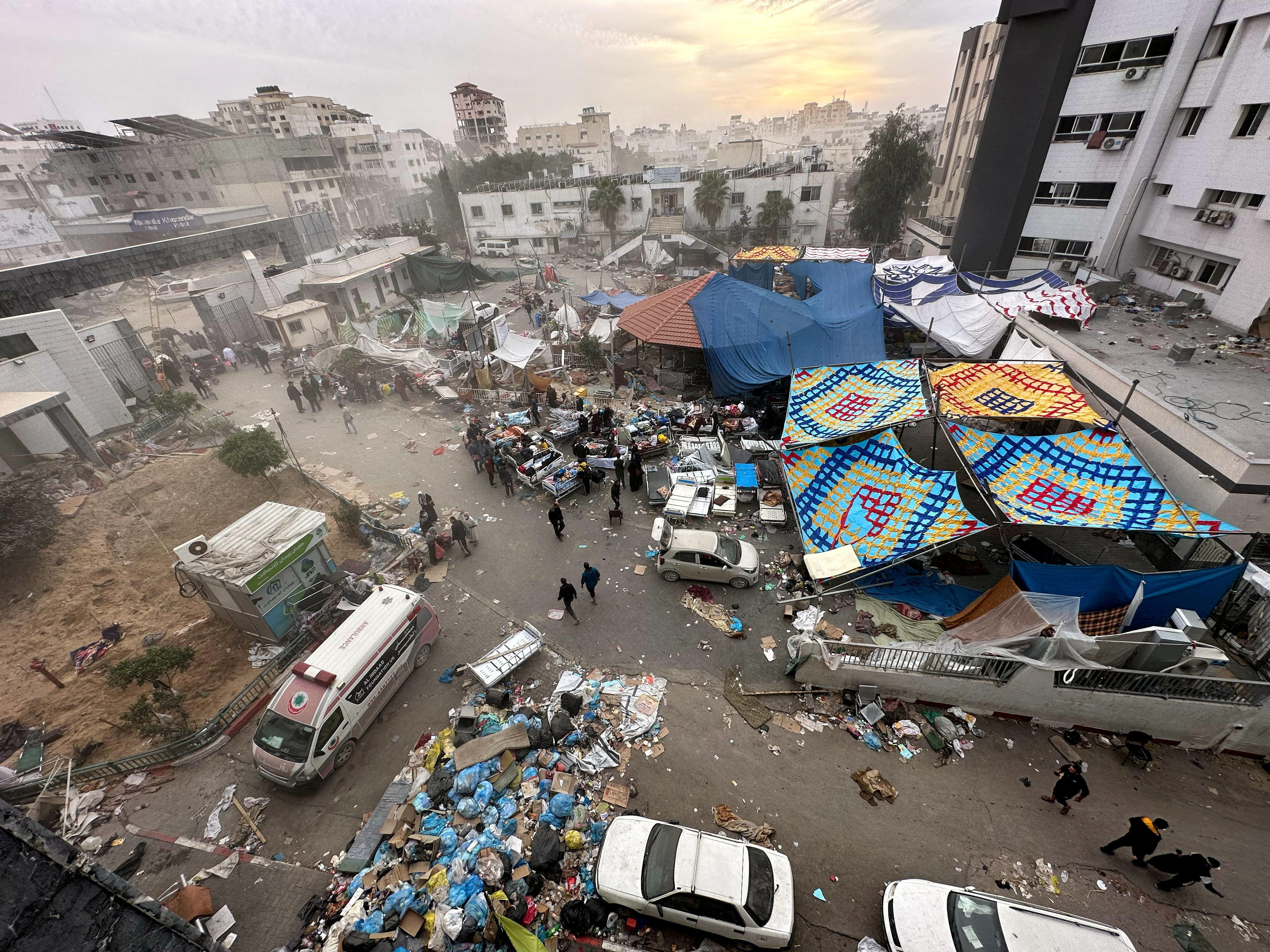 Palestinians inspect Al Shifa Hospital which was raided by Israeli forces during its ground operation, amid a temporary truce between Israel and the Palestinian Islamist group Hamas, in Gaza City, November 25