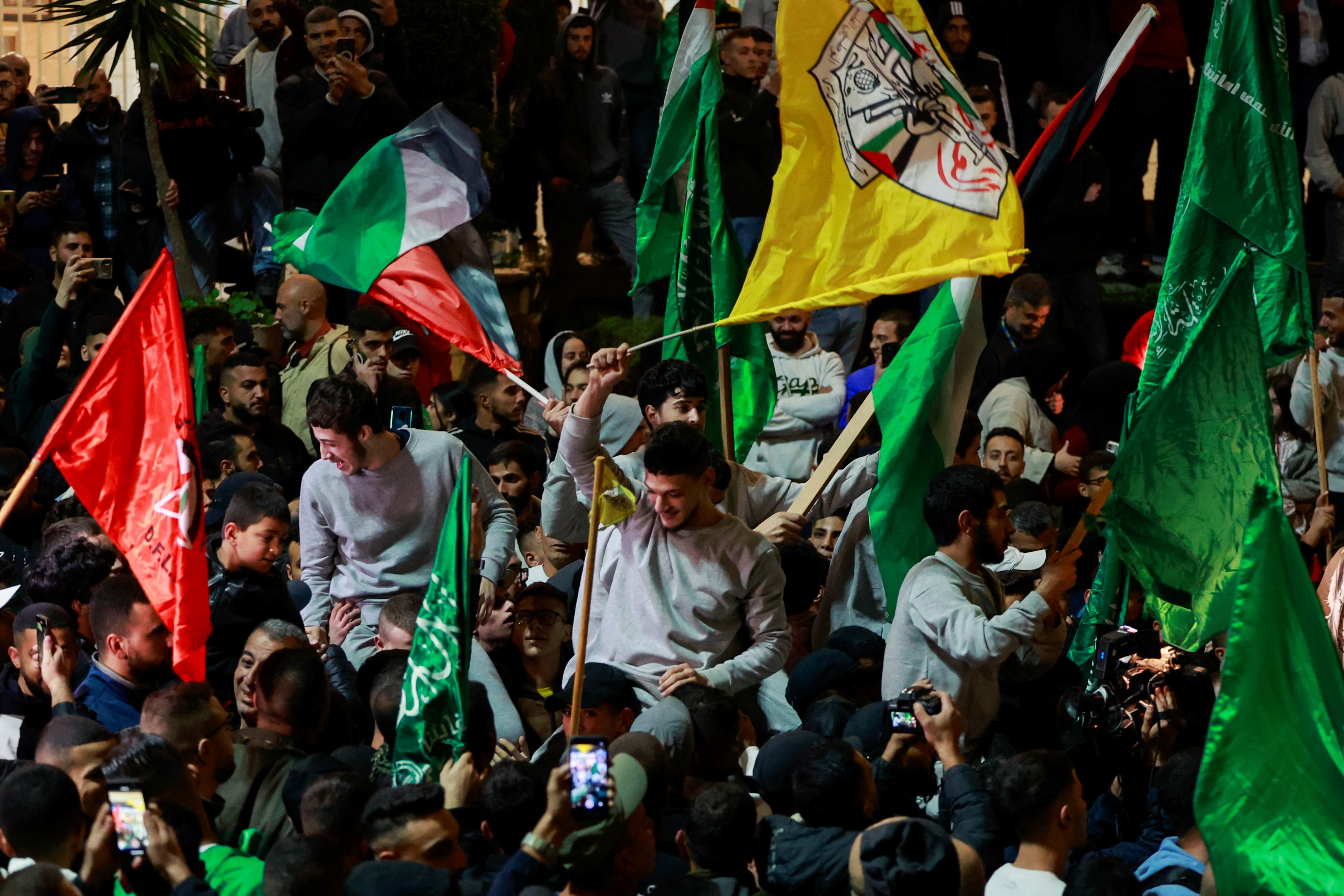 Released Palestinian prisoners react after leaving the Israeli military prison, Ofer, amid a hostages-prisoners swap deal between Hamas and Israel, near Ramallah in the Israeli-occupied West Bank November 26