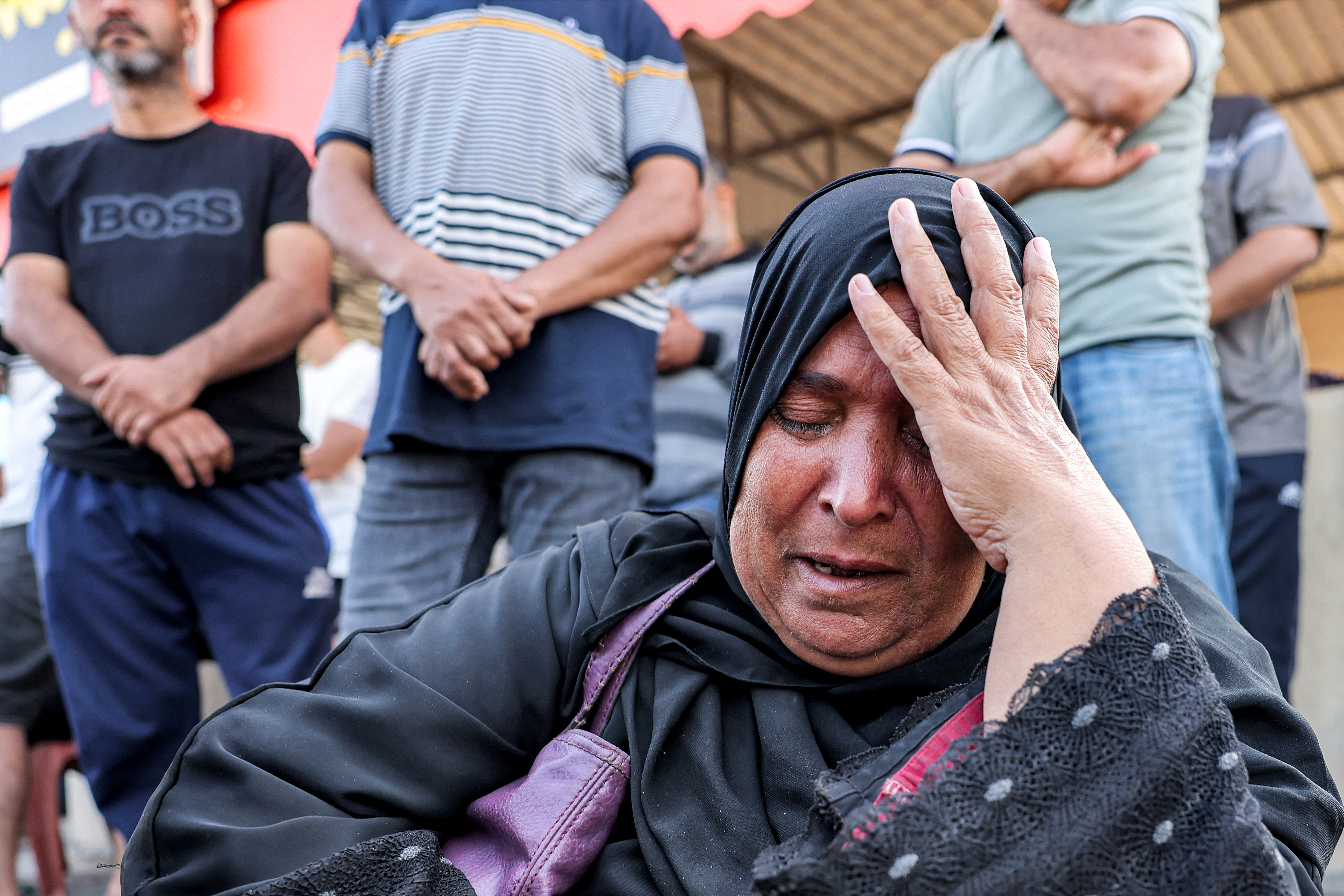 Sabah Said, a Palestinian-Egyptian dual national, reacts as she waits at the Rafah border crossing with Egypt in the southern Gaza