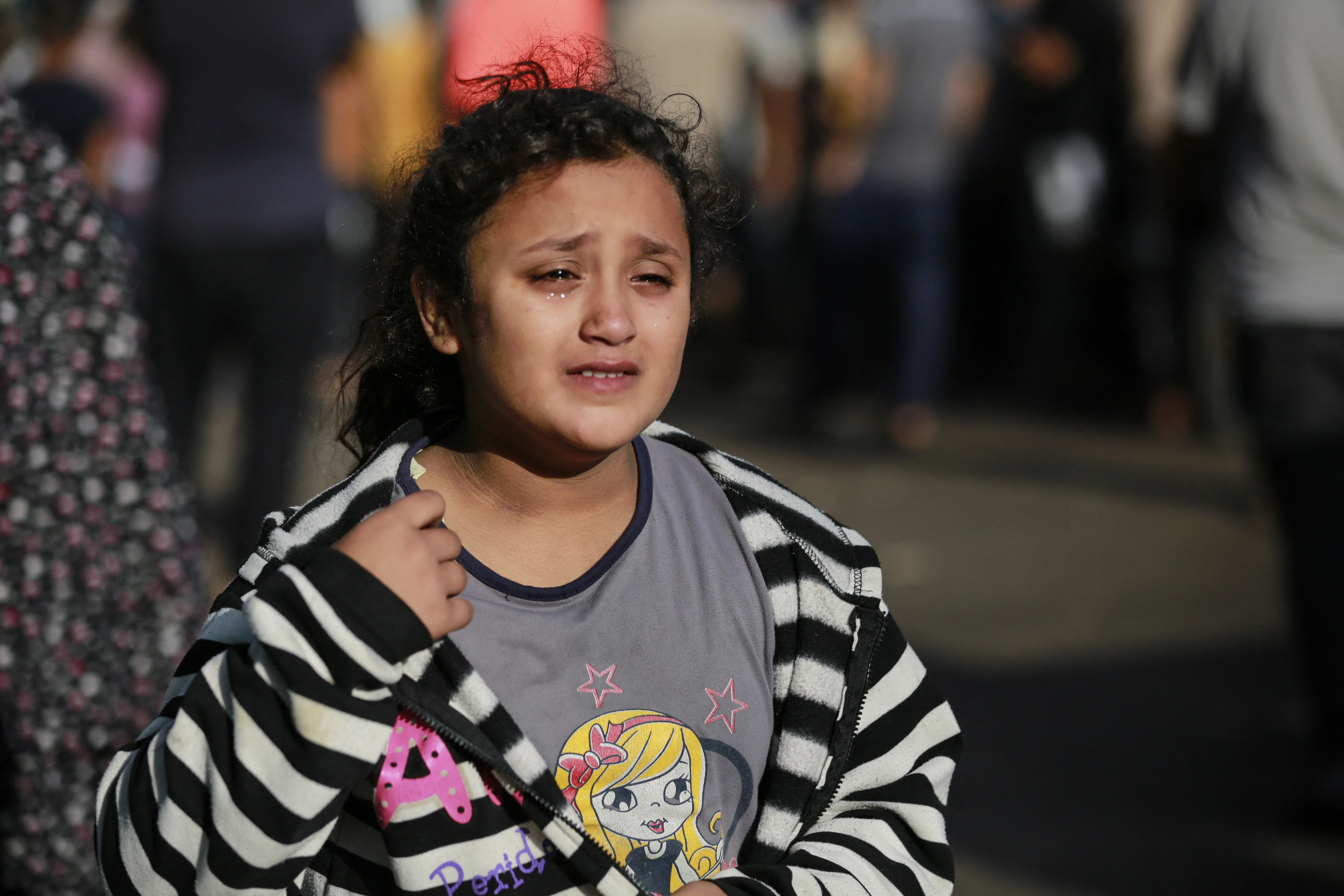 The relative of a person killed a day earlier in an Israeli strike that hit the entrance of Al-Shifa hospital in Gaza City, reacts during a funeral held for the victims on November 4