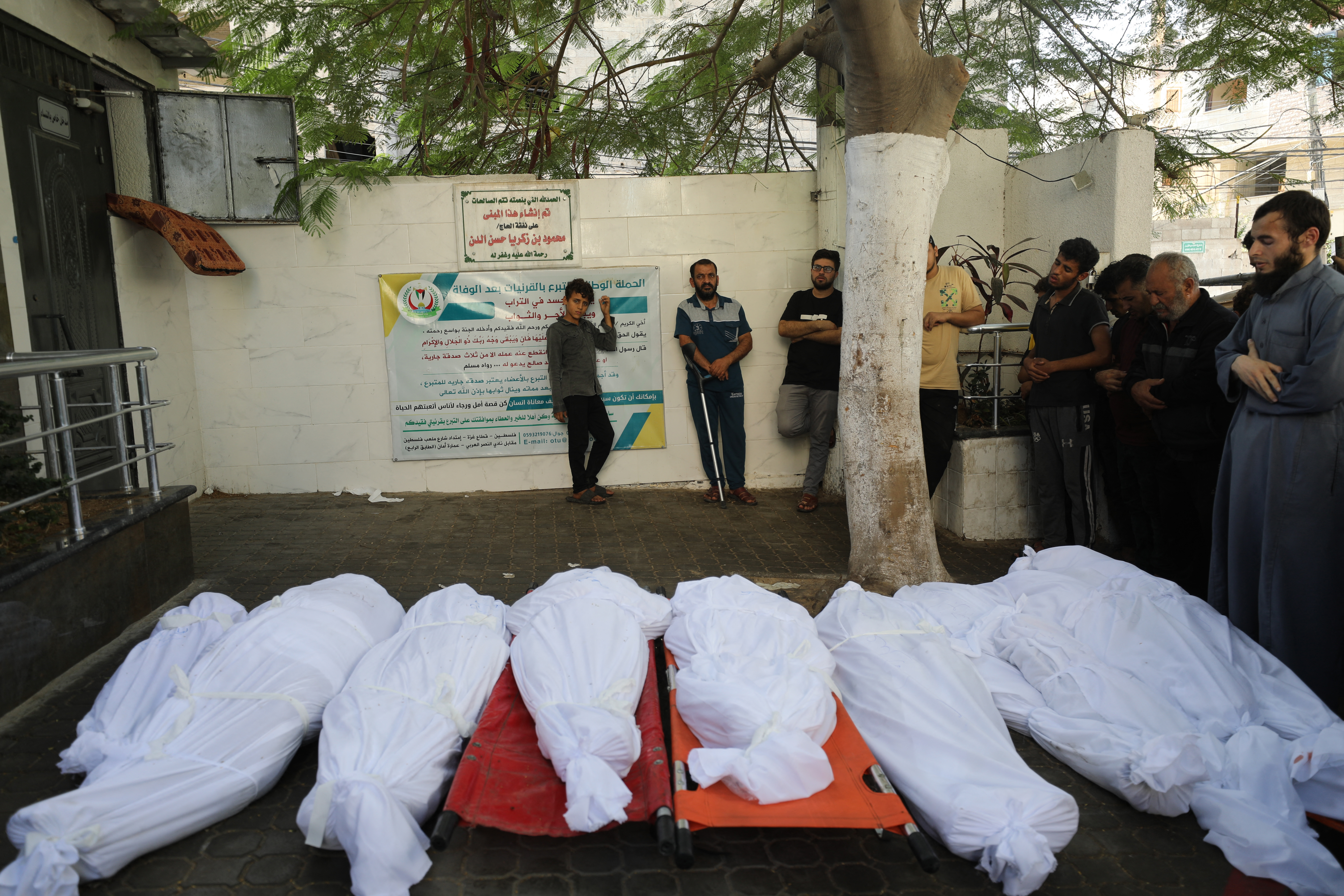 Palestinians pray over the bodies of those killed following Israel's bombardment of Gaza City's eastern suburb of Shujaiya on November 4