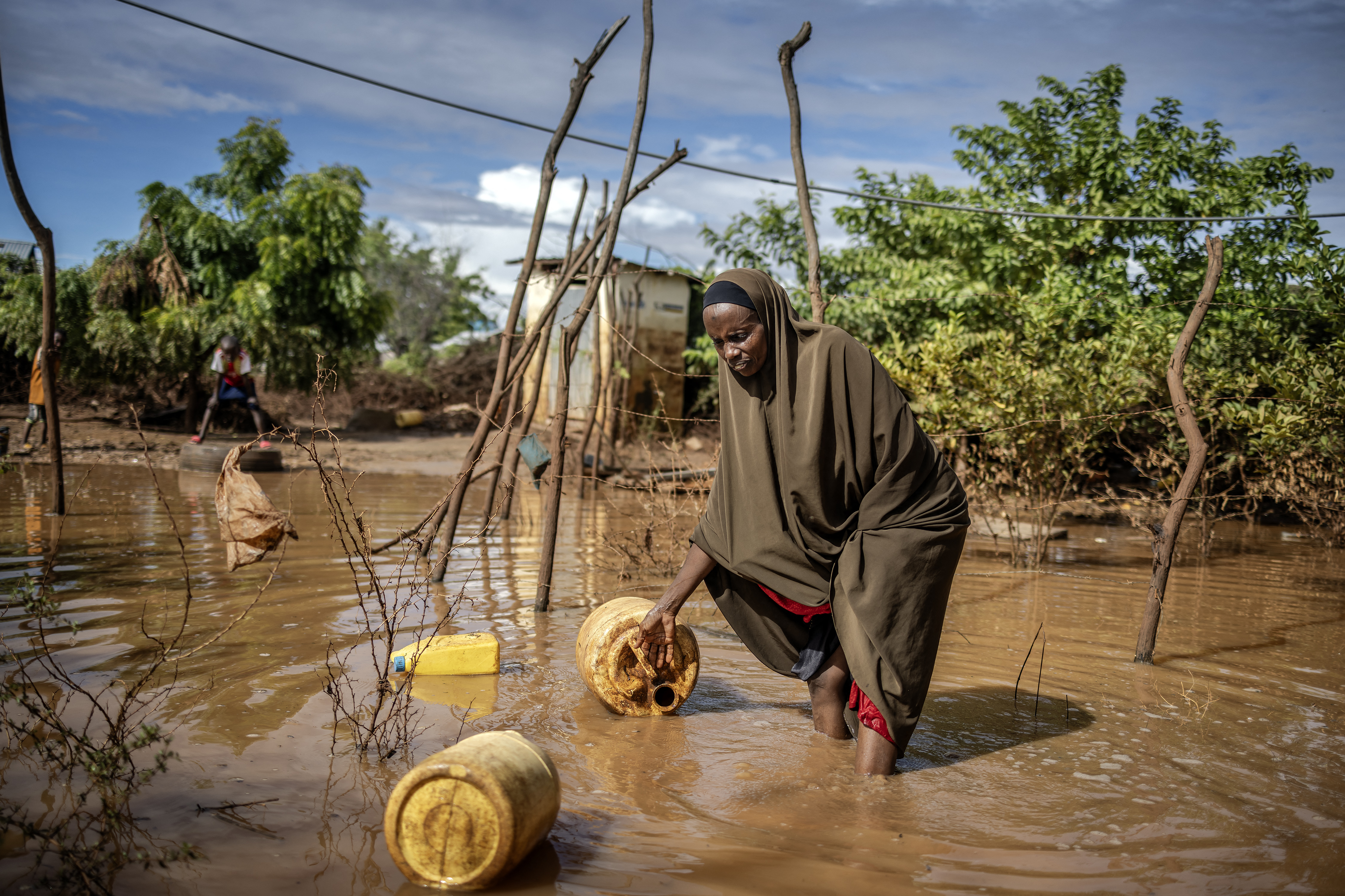 Halan Subeir Salat, 35, tries to collect some of her belongings at the inundated area where she lives following flash floods in Garissa.