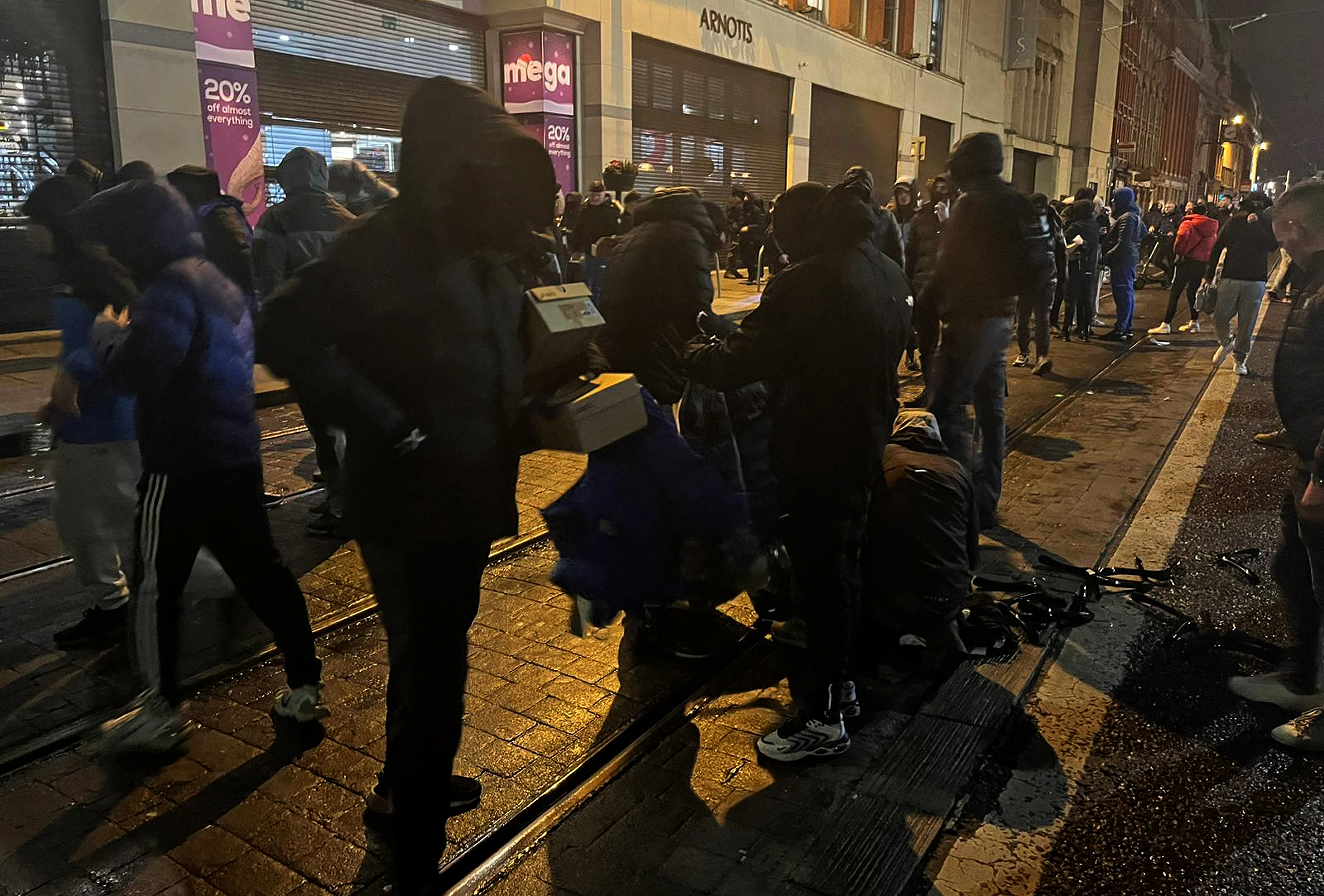 Protestors sort through looted goods in Dublin
