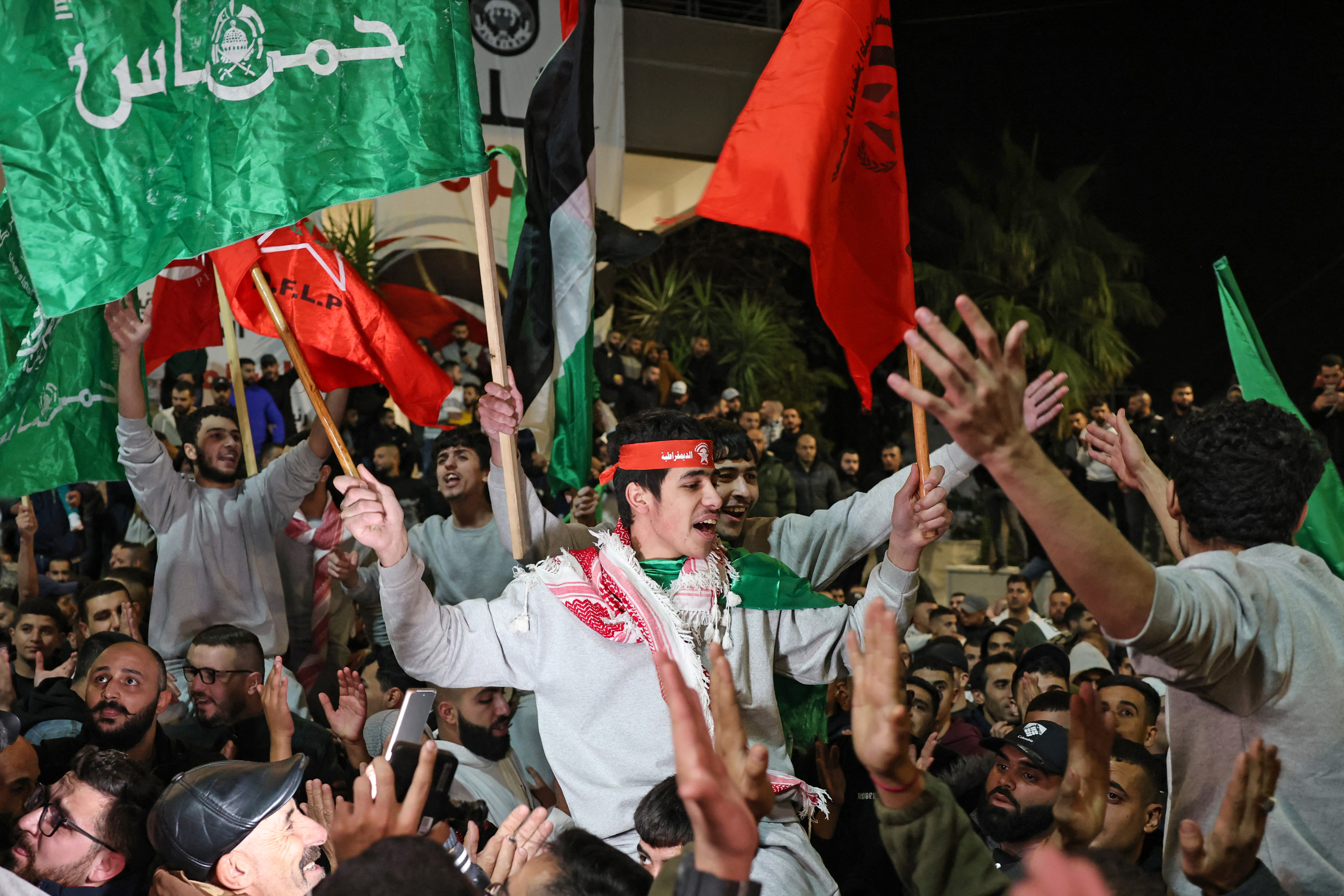 Released Palestinian prisoners react after leaving the Israeli military prison, Ofer, amid a hostages-prisoners swap deal between Hamas and Israel, near Ramallah in the Israeli-occupied West Bank November 26