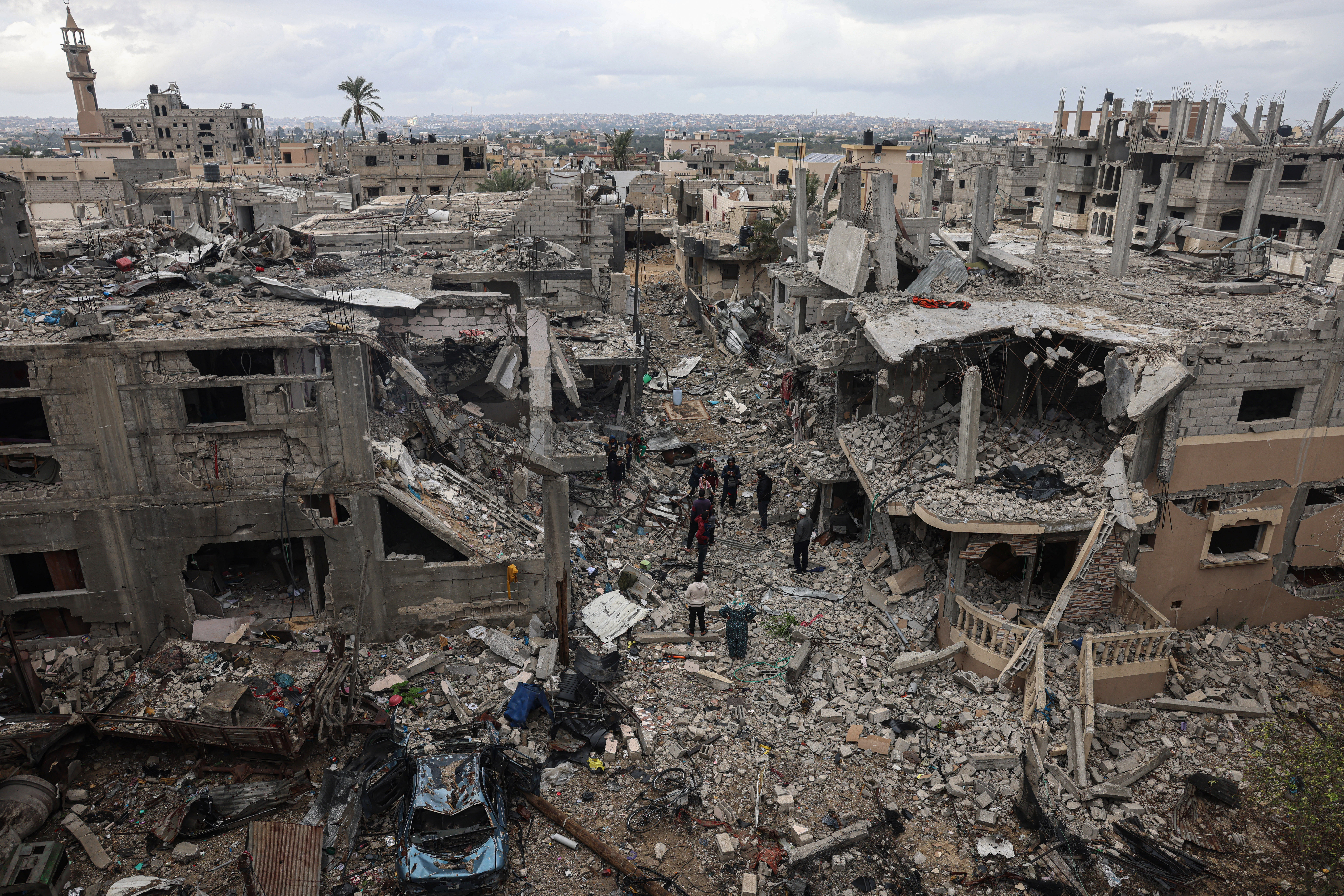 Palestinians inspect the destruction caused by Israeli strikes on their homes in the village of Khuzaa, near Abasan east of Khan Yunis near the border fence between Israel and the southern Gaza