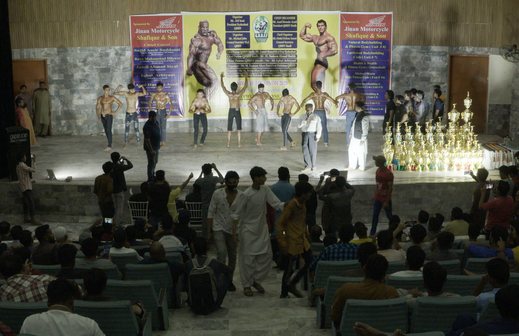 Bodybuilders pose for the judging panel