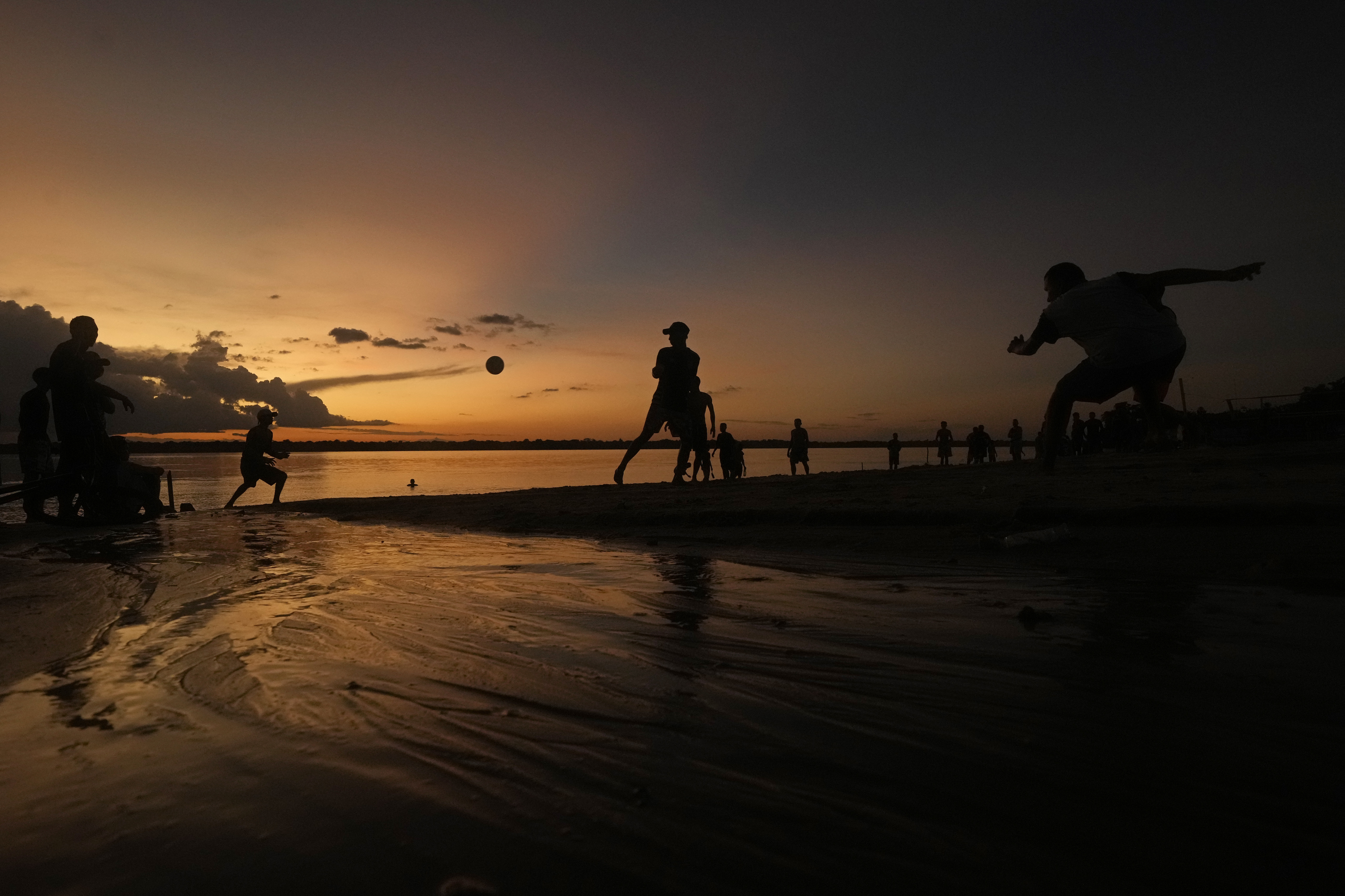 Residents play ball at sunset on the sands of the Tocantis River, in the city of Mocajuba, Para state, Brazil.