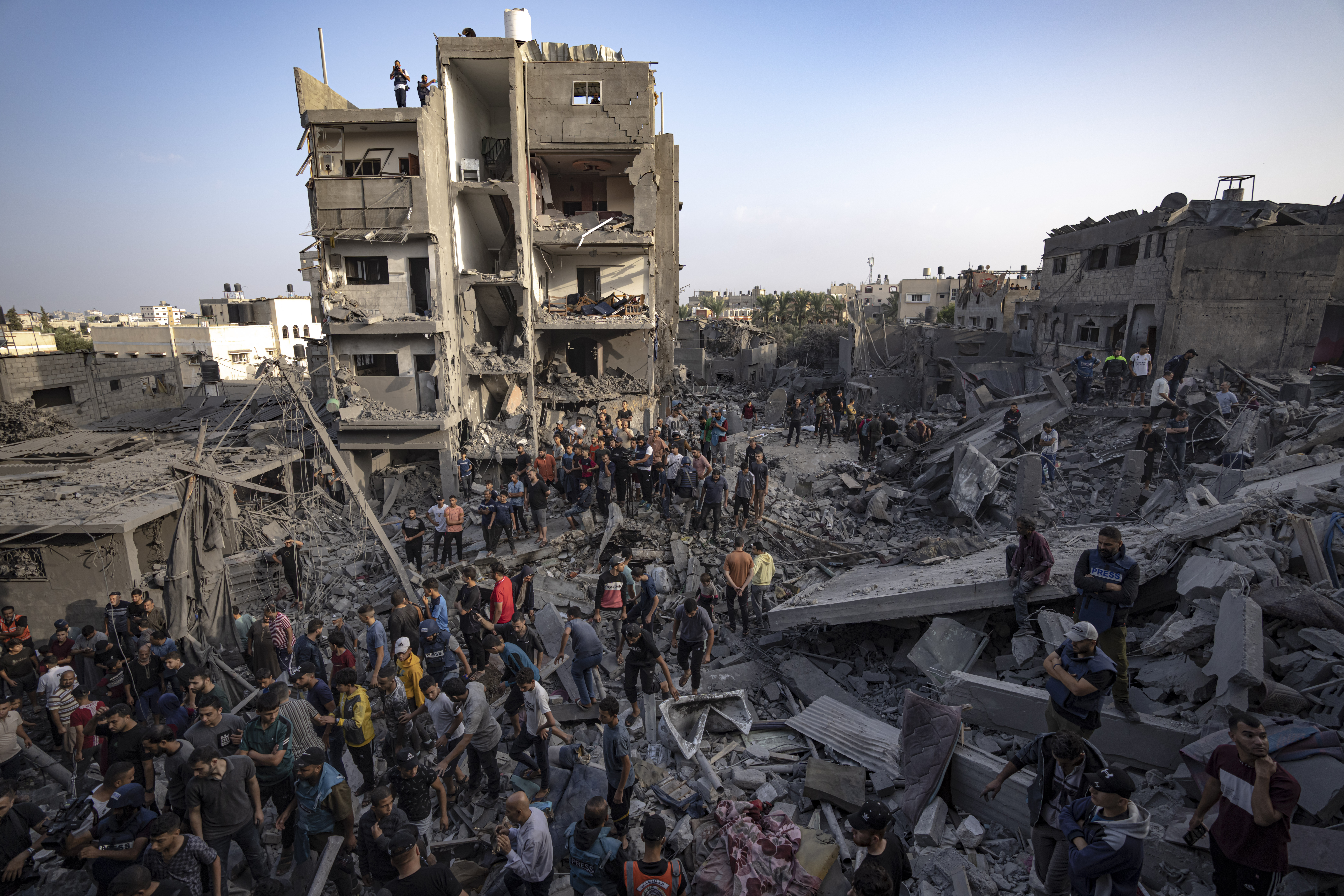 Palestinians look for survivors of the Israeli bombardment in the Maghazi refugee camp in the Gaza Strip, Sunday