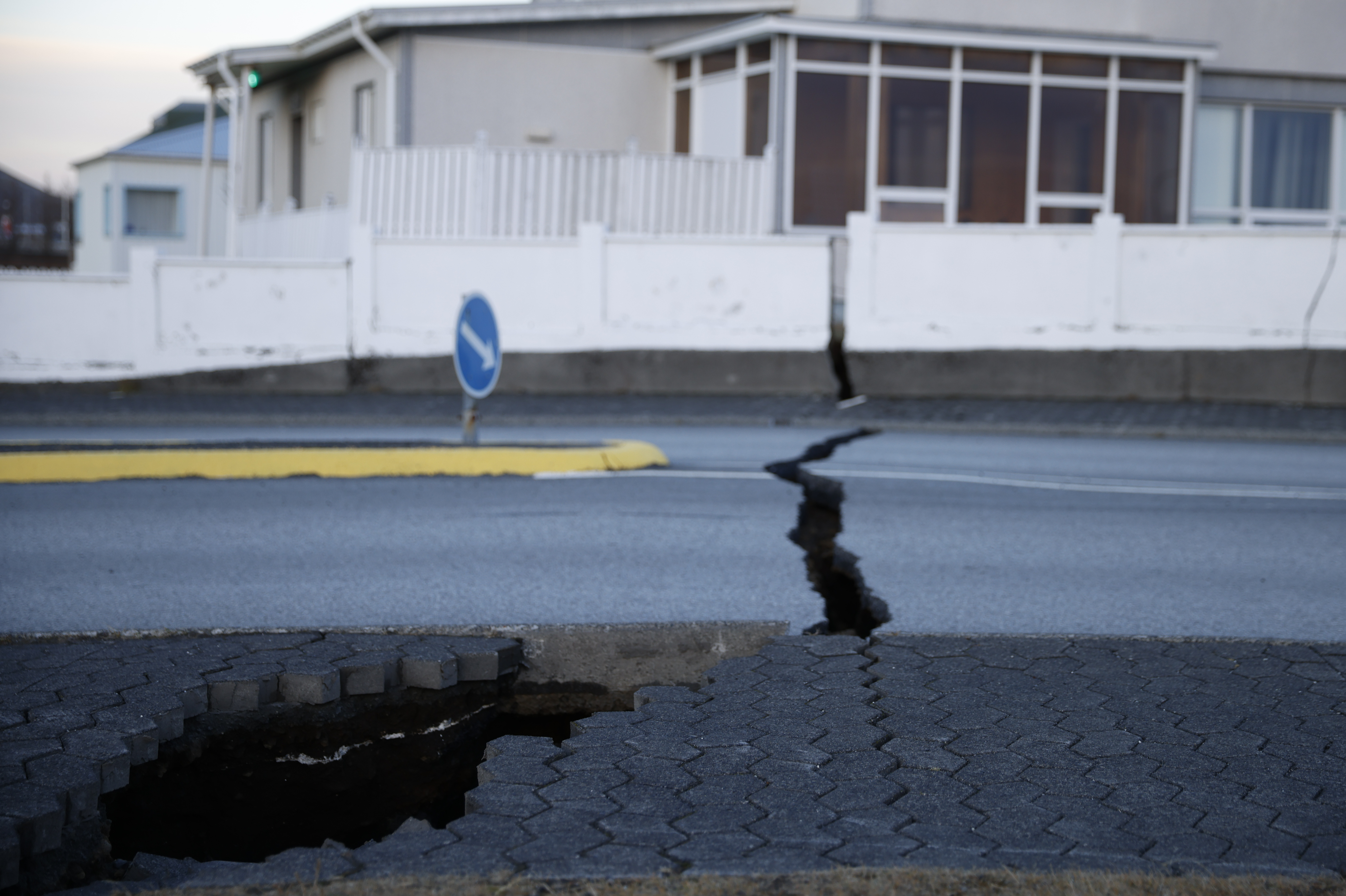 A fissure stretches across a road in the town of Grindavik, Iceland.