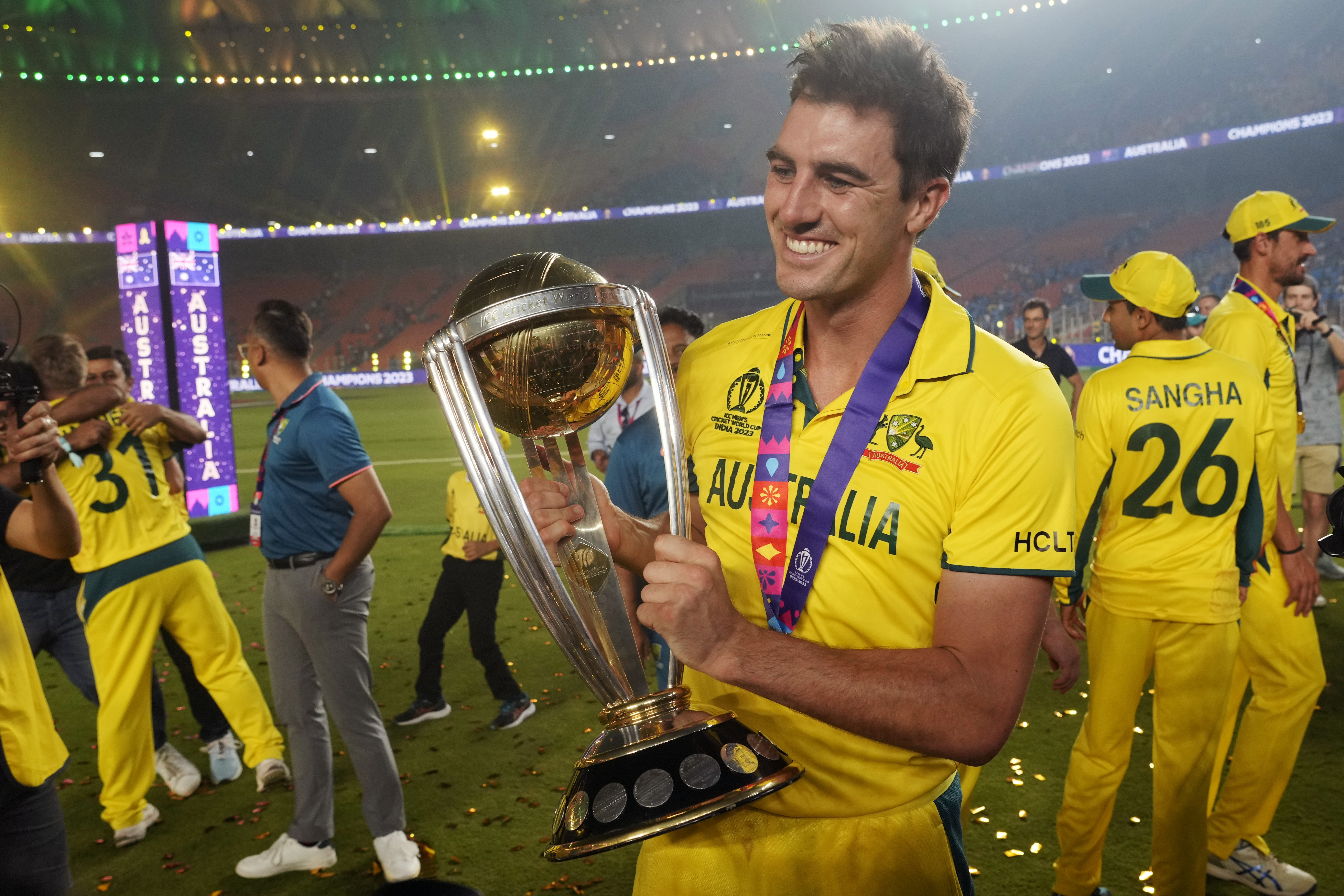 Australia's captain Pat Cummins poses for a photograph with the trophy after Australia won the ICC Men's Cricket World Cup final match against India in Ahmedabad, India.