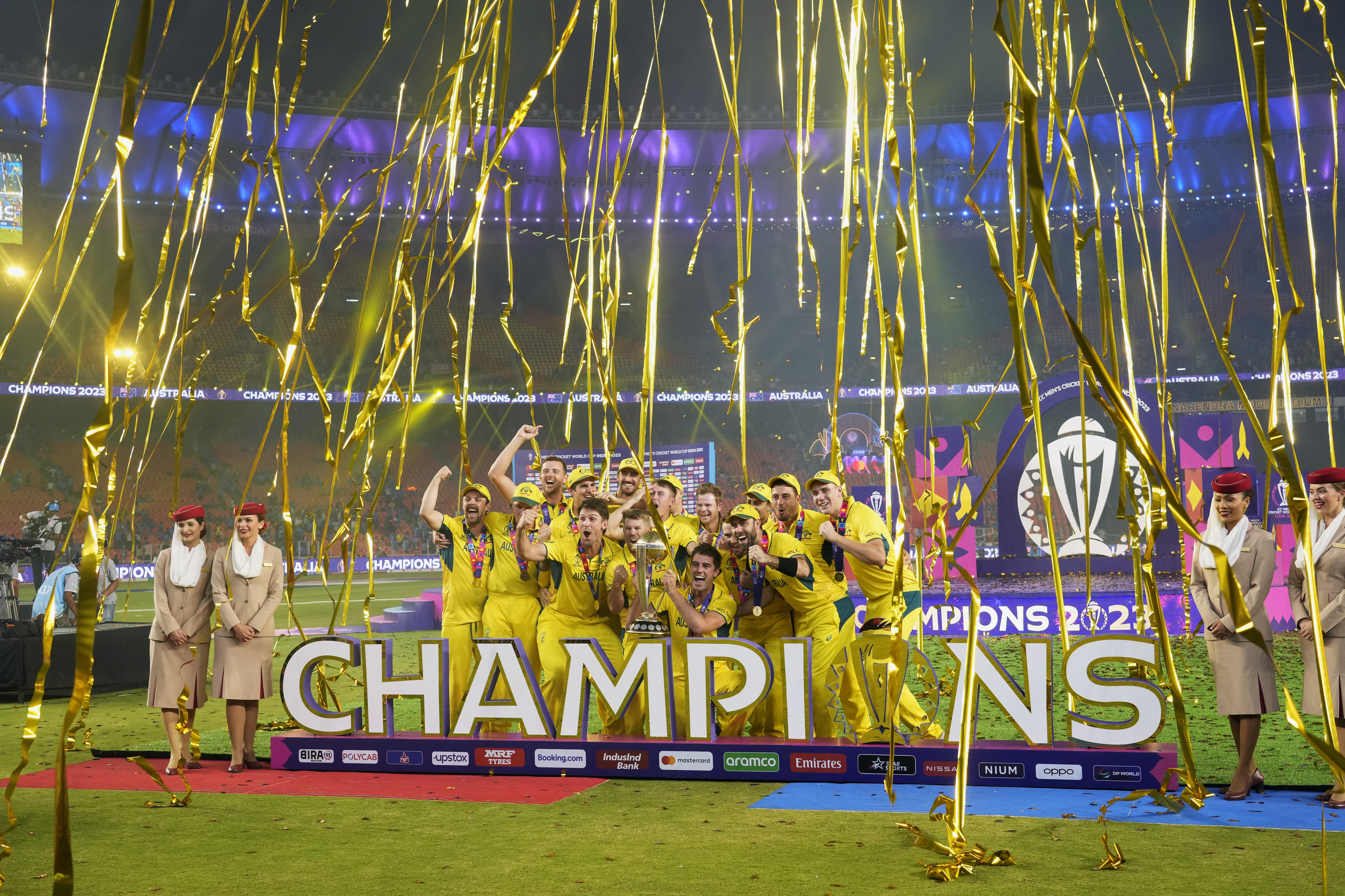 Australia players celebrate with the trophy after Australia won the ICC Men's Cricket World Cup final match against India in Ahmedabad, India.