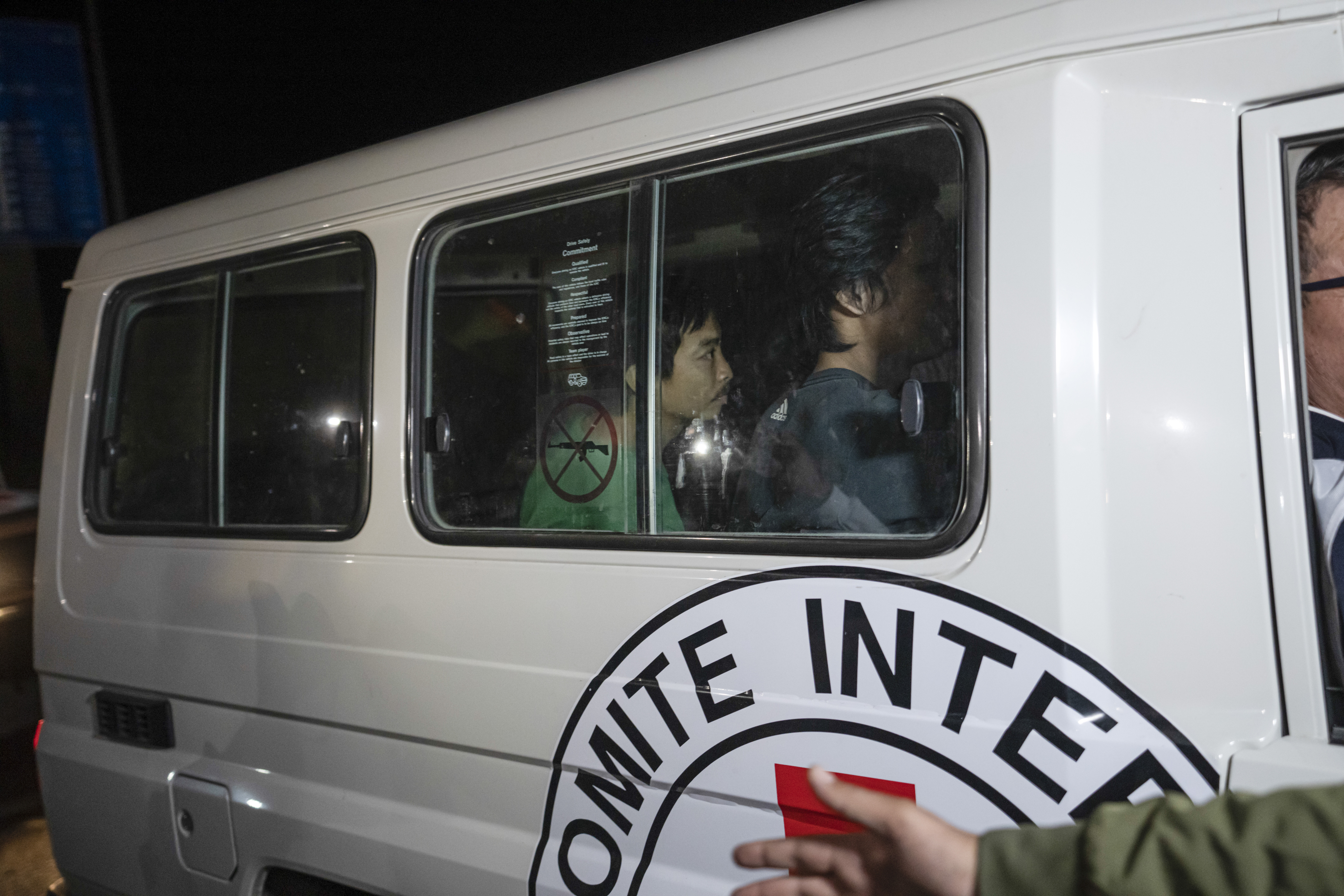 A Red Cross vehicle carrying Thai hostages drives by at the Gaza Strip crossing into Egypt in Rafah on Saturday, Nov. 25, 2023. (AP Photo/Fatima Shbair)