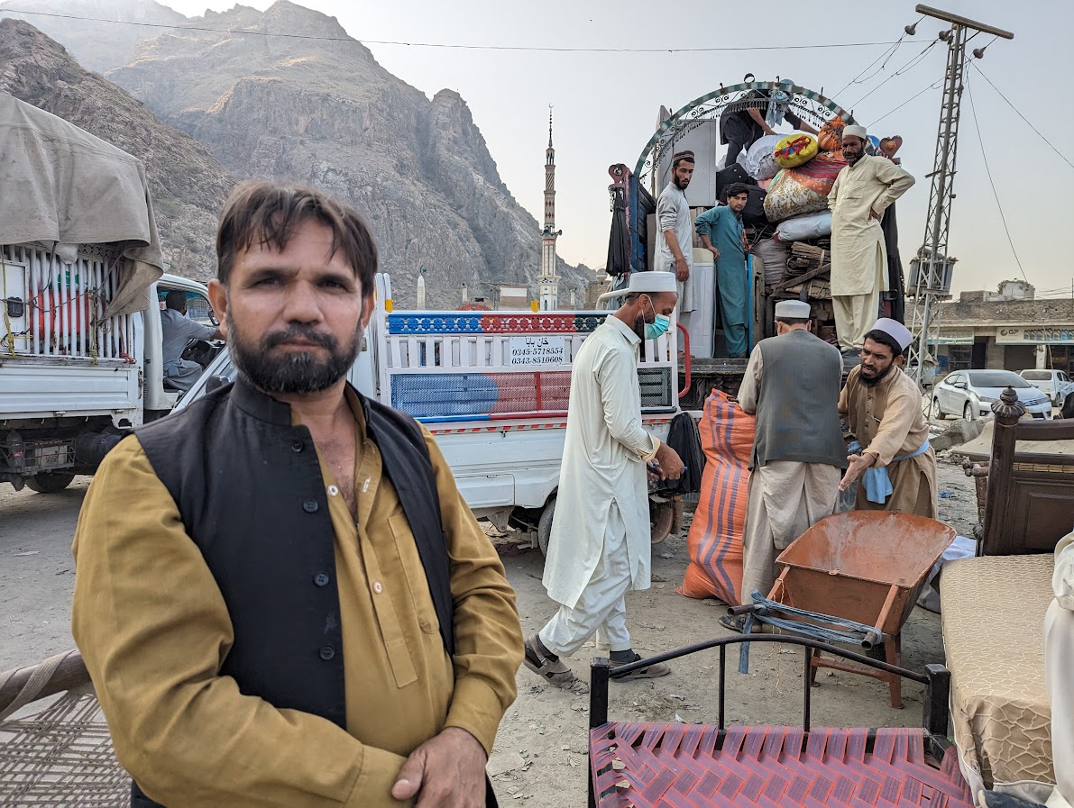 Khair Muhammad standing in front of truck with his belongings out Torkham border crossing-1699011628