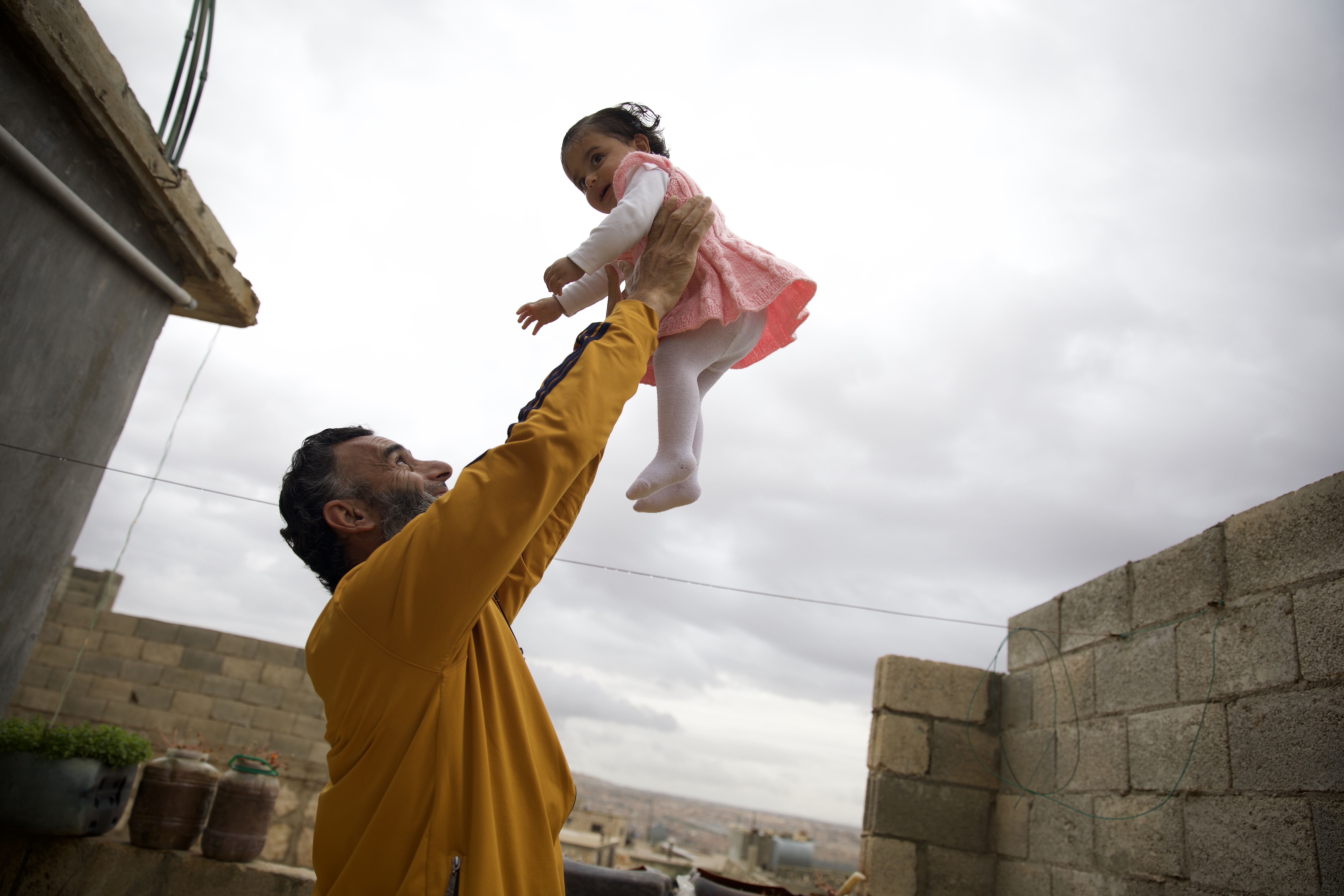 Nader Mohammed Al-Bakri plays with her daughter Jouri