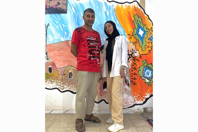 A photo of two people standing next to each other.